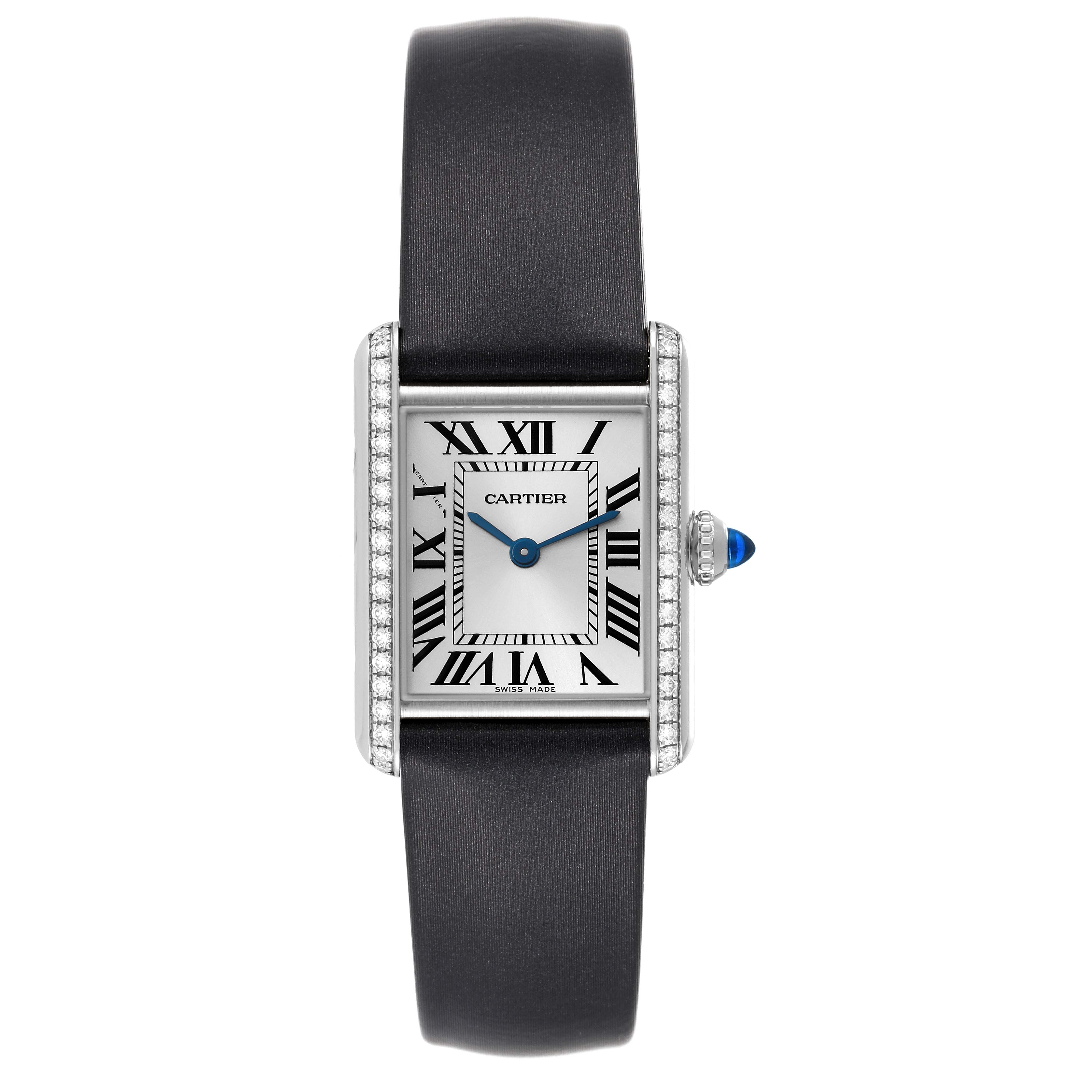 The image shows a Cartier Tank Must W4TA0016 Women's Stainless Steel Silver Dial W4TA0016 Women's Stainless Steel Silver Dial watch from the front, displaying its face, dial, strap, and crown with a blue cabochon.