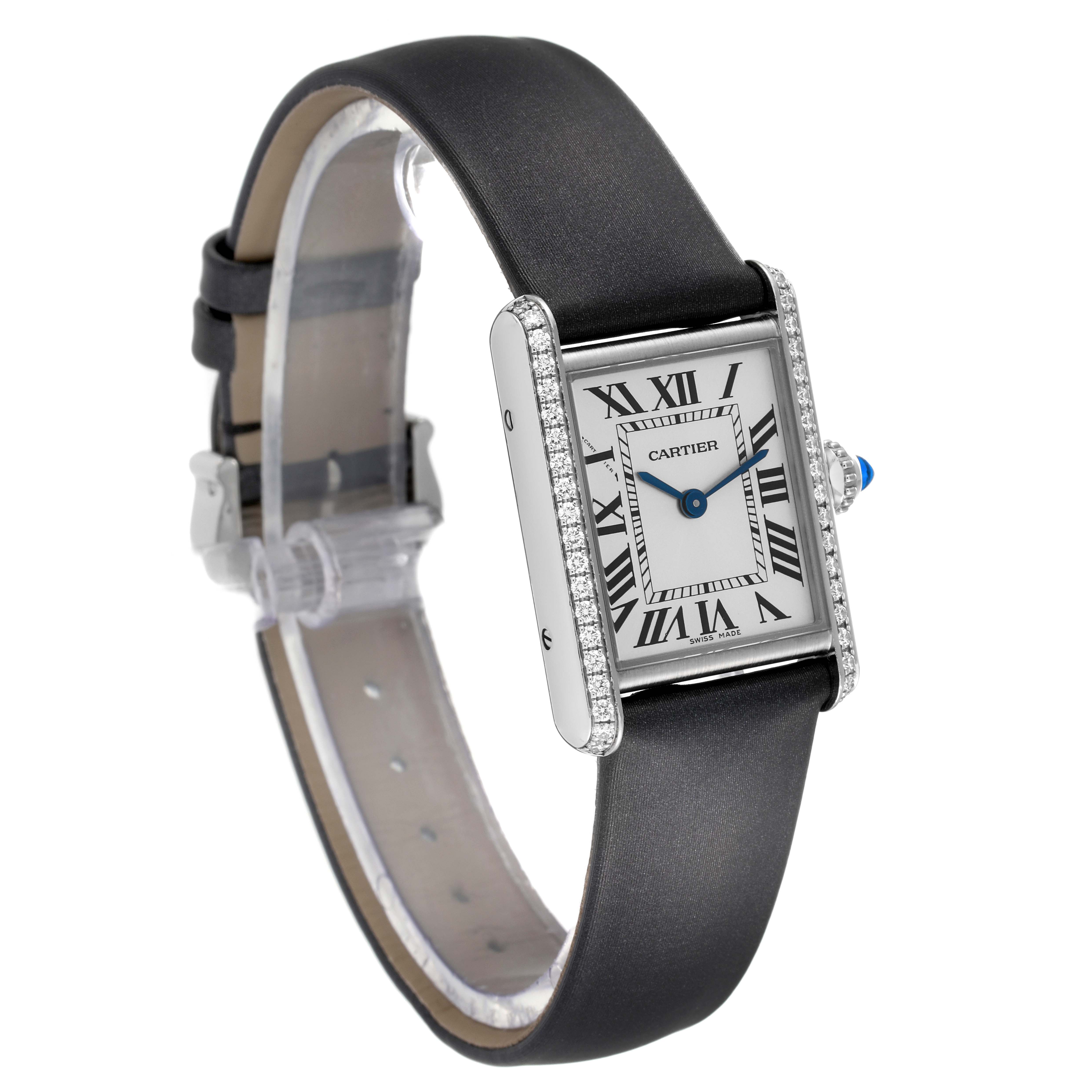 The image shows a Tank Must watch by Cartier at a slight side angle, featuring its rectangular case and black leather strap.