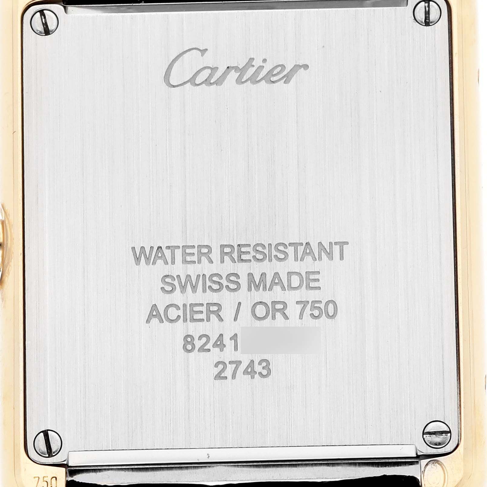 The image shows the back of a Cartier Tank Solo W1018755 Women
s Steel and Gold (two tone) Silver Dial watch, featuring engraved text and screws at the corners.