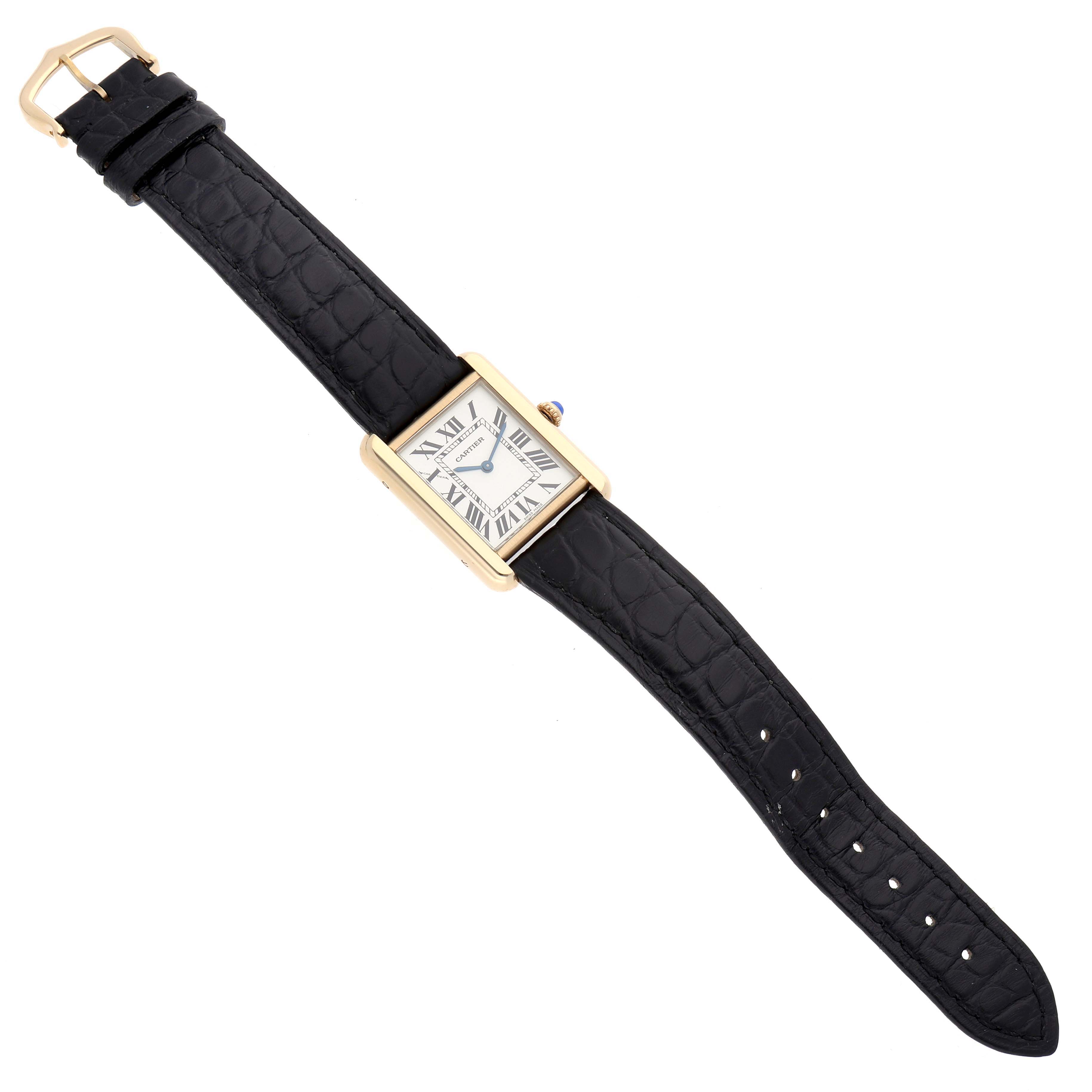 The Cartier Tank Solo W1018755 Women
s Steel and Gold (two tone) Silver Dial watch is shown from a top-down angle, displaying the face, gold case, and black leather strap.
