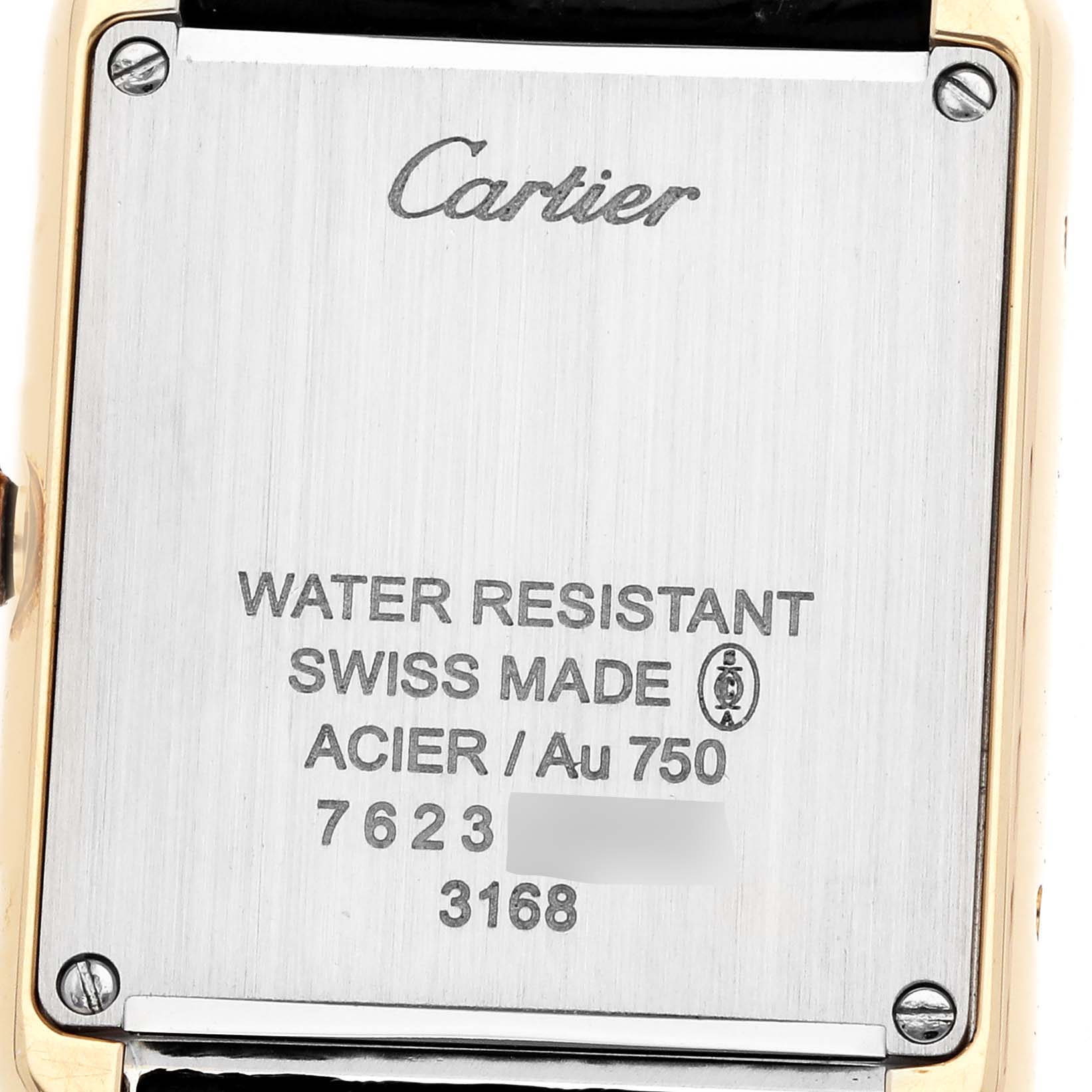 The image shows the back case of the Cartier Tank Solo W5200002 Women
s Steel and Gold (two tone) Silver Dial watch, displaying branding and specifications.