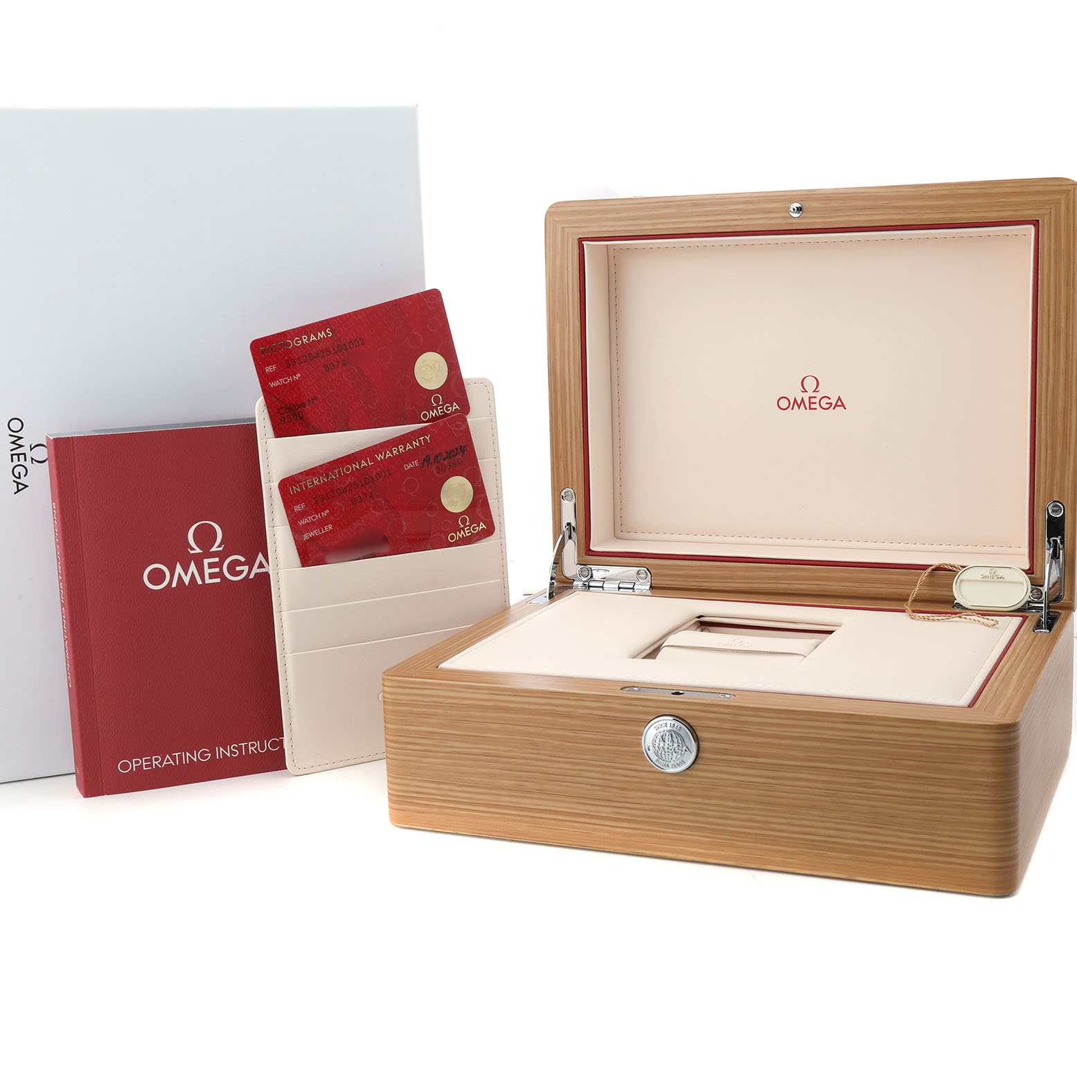 The image shows the Omega Speedmaster 331.20.42.51.01.002 Men's Rose Gold Black Dial accessories, including a wooden box, warranty cards, and an instruction booklet.