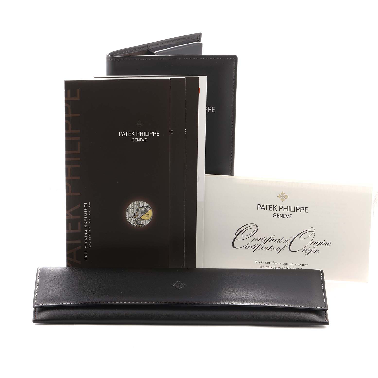 The image shows Patek Philippe Calatrava 5127R Men
s Rose Gold Silver Dial accessories including manuals, a certificate, and a leather pouch, all from a frontal angle.