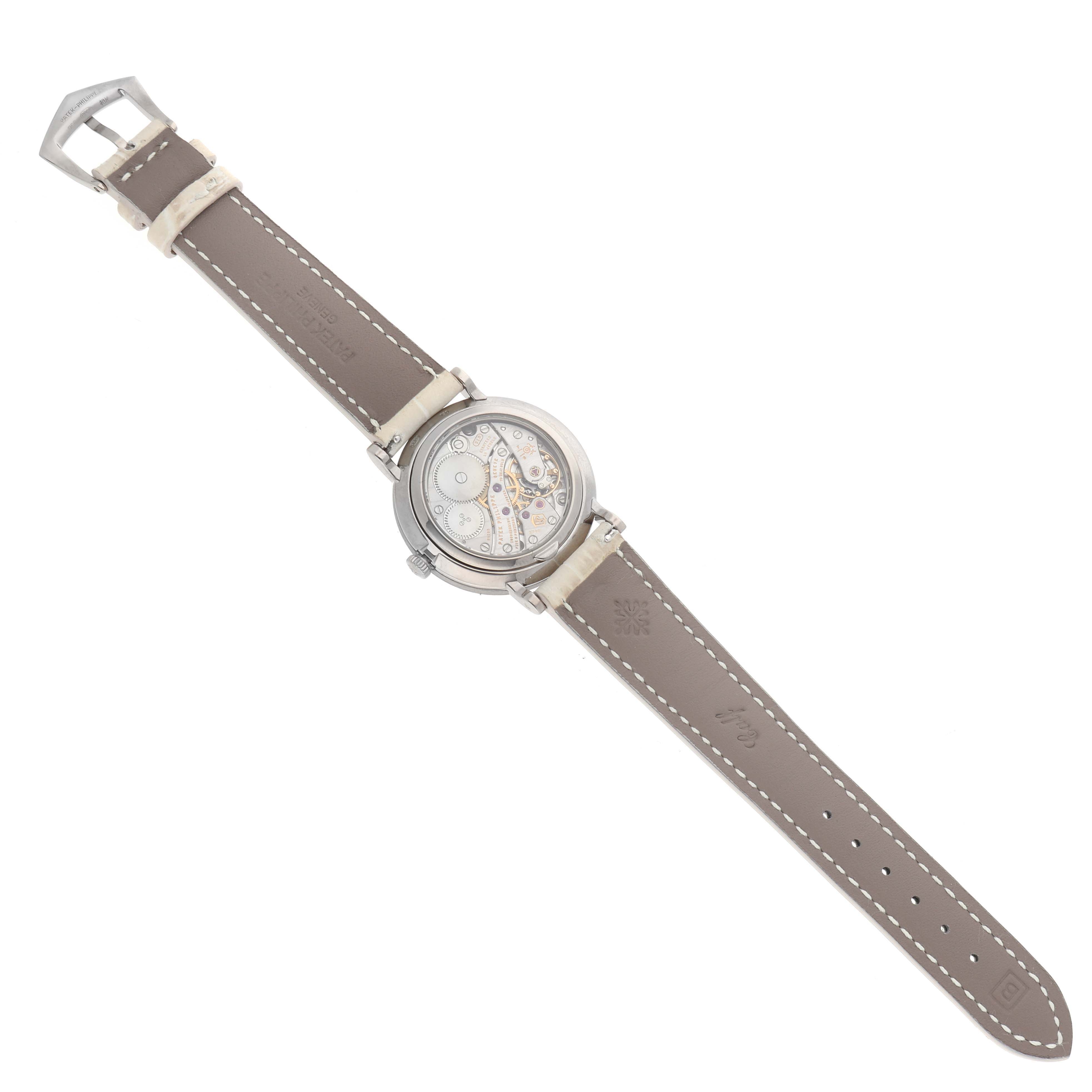 The Patek Philippe Calatrava 7120 Women
s White Gold Beige Dial watch is shown from the back, highlighting its movement and leather strap.