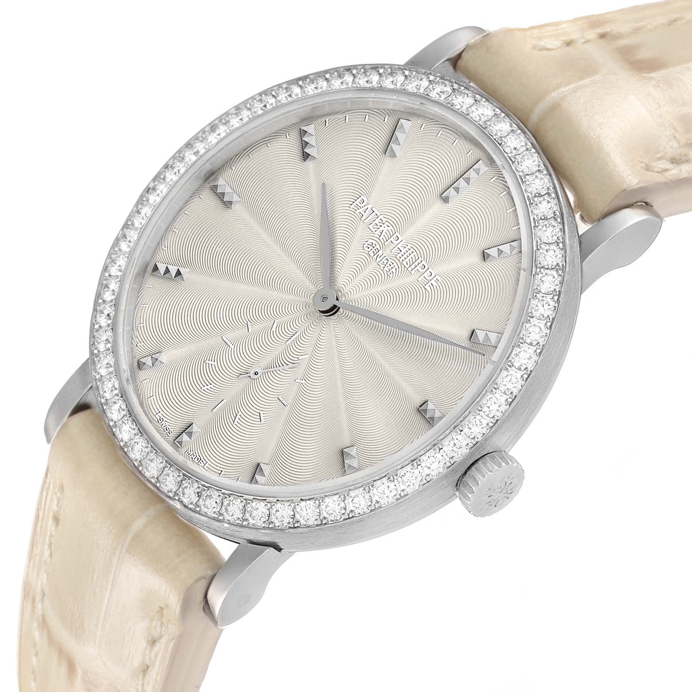 The Patek Philippe Calatrava 7120 Women's White Gold Beige Dial watch is shown from an angled side view, highlighting its textured dial, diamond-set bezel, and leather strap.