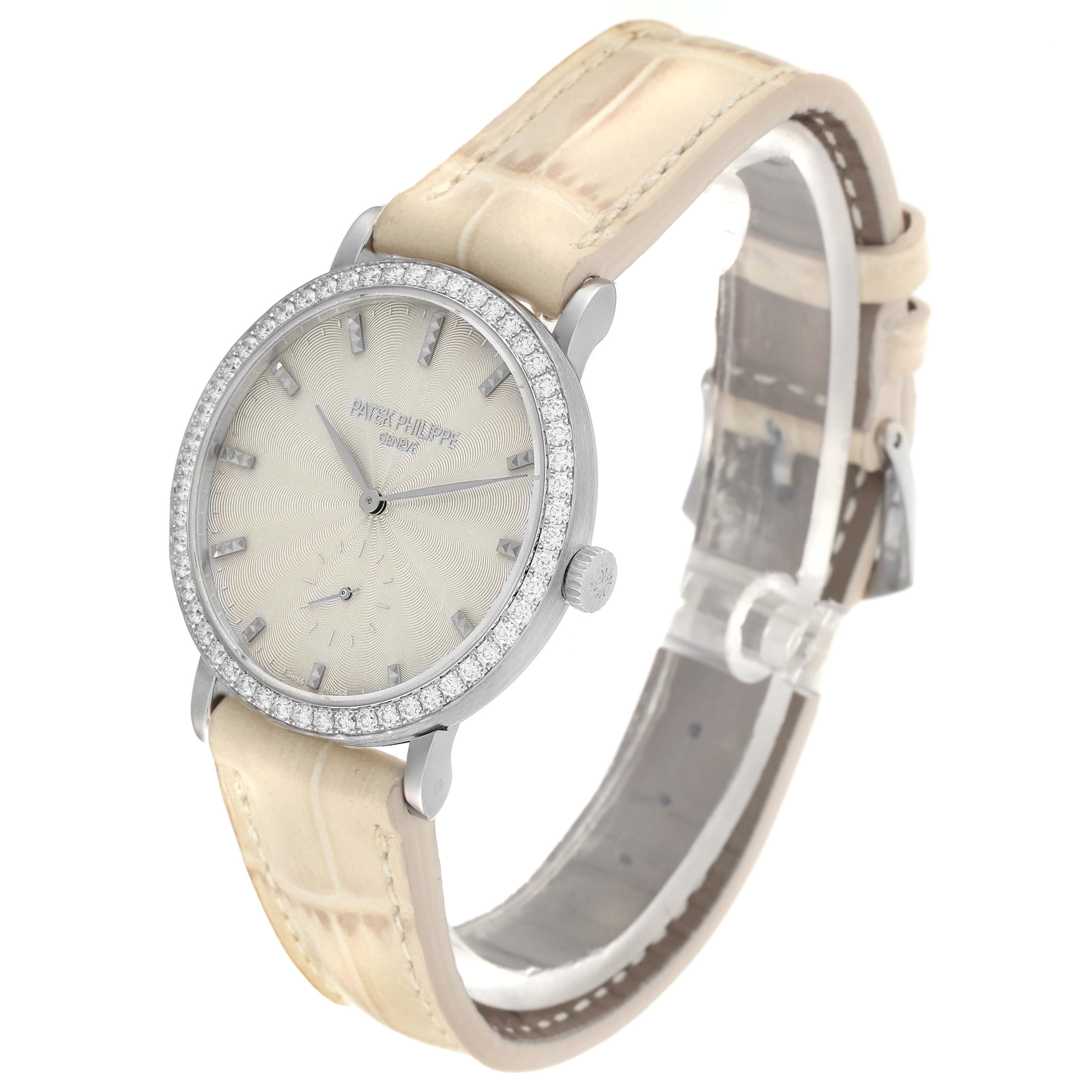 The Patek Philippe Calatrava 7120 Women
s White Gold Beige Dial watch is shown at a slight angle, displaying its diamond-set bezel, dial, and leather strap.