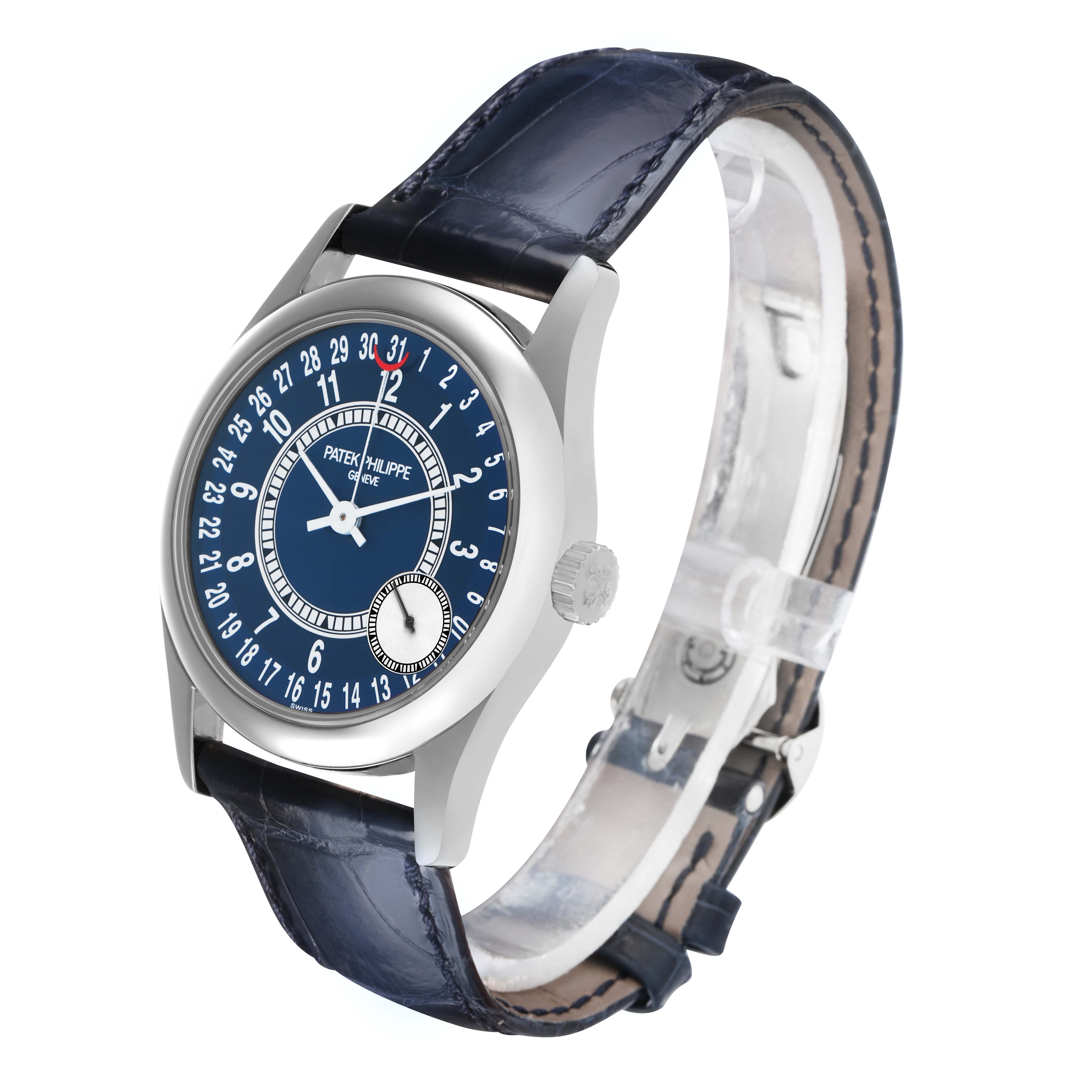 The Patek Philippe Calatrava 6000G Men
s White Gold Blue Dial watch is shown at a side angle, highlighting the face, crown, and blue leather strap.