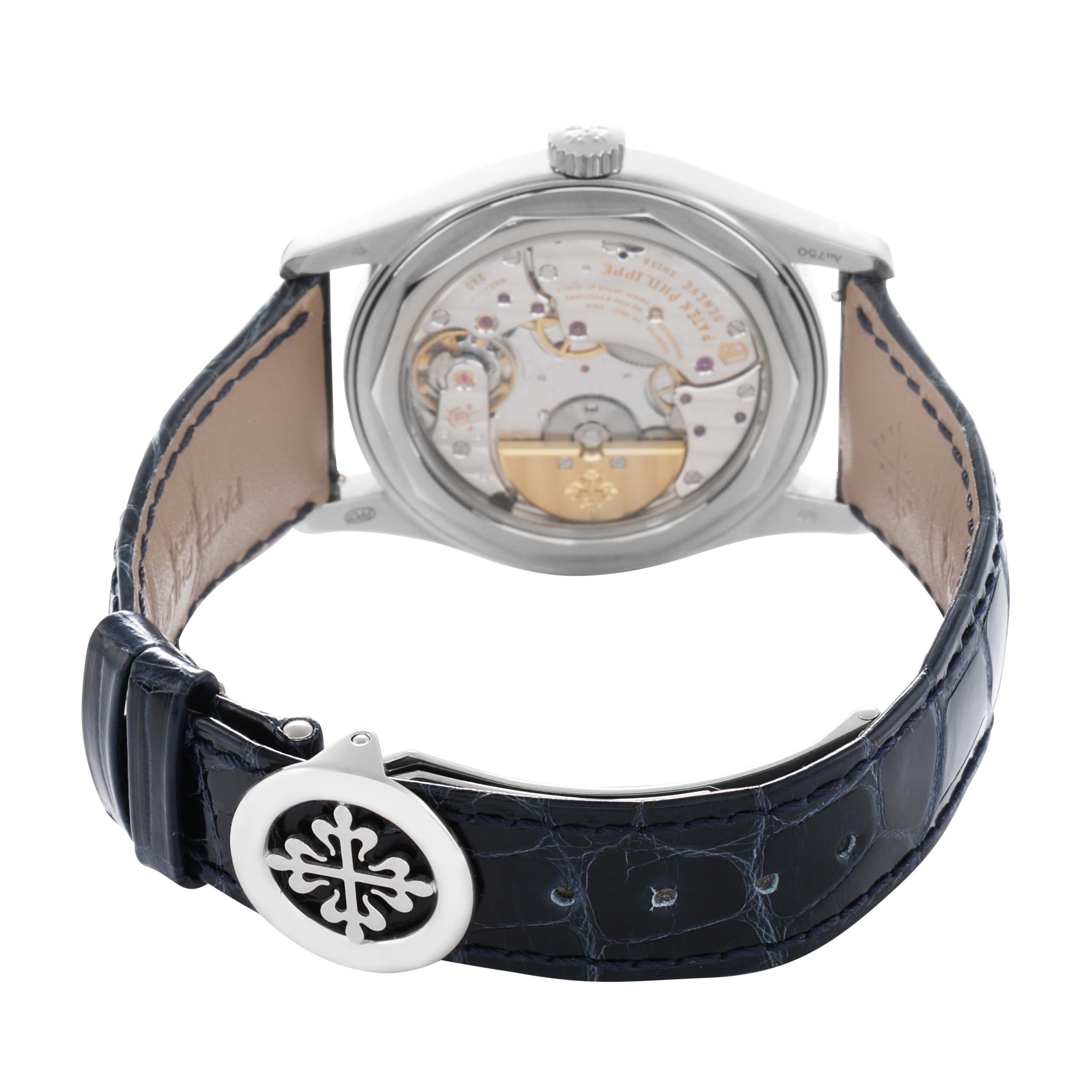 The Patek Philippe Calatrava 6000G Men
s White Gold Blue Dial watch is shown from the back, highlighting the mechanical movement and blue leather strap.
