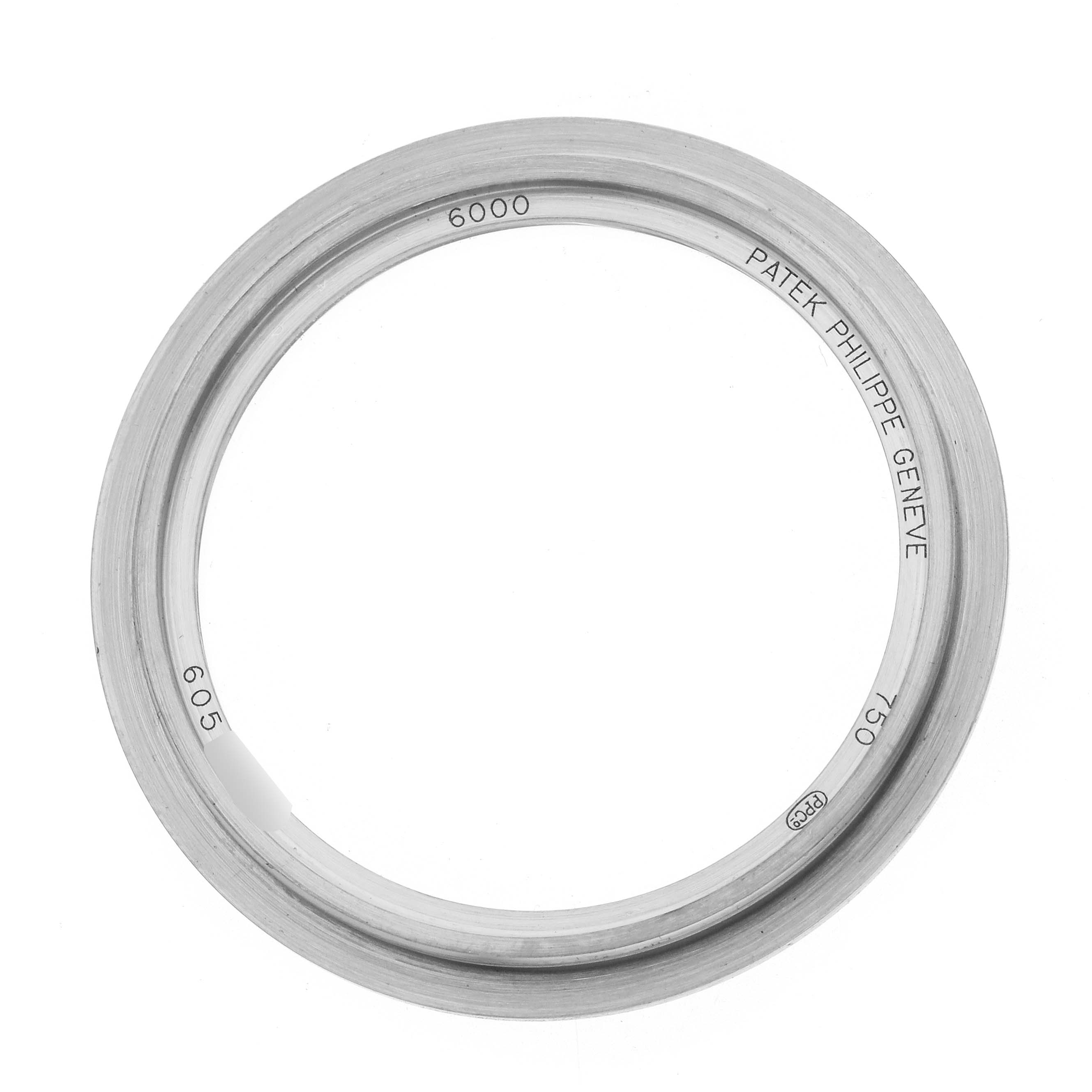 The image shows a top-down view of a Patek Philippe Calatrava 6000G Men
s White Gold Blue Dial watch bezel, featuring engravings with model details.