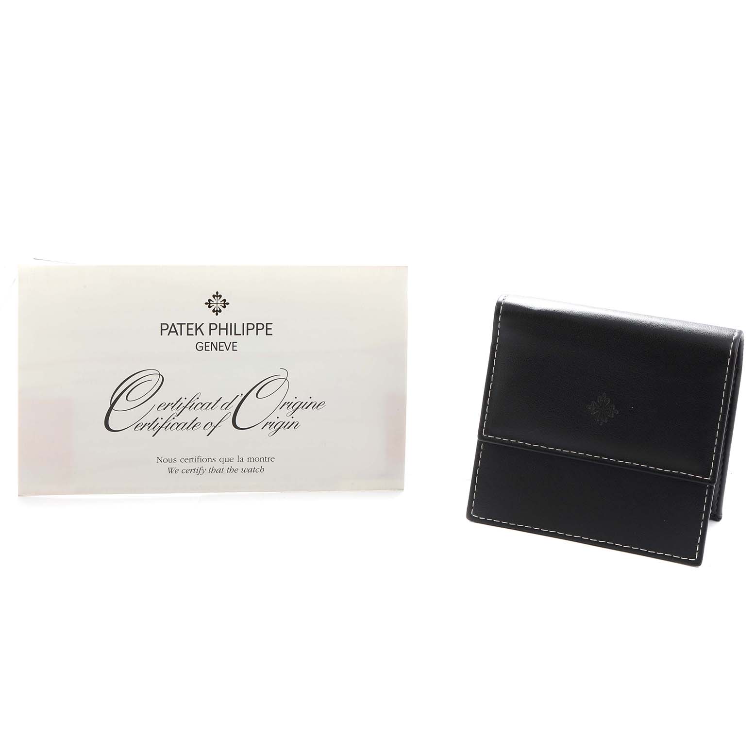 The image shows a Patek Philippe Calatrava 6000G Men
s White Gold Blue Dial model
s Certificate of Origin and a black leather watch pouch from a front angle.