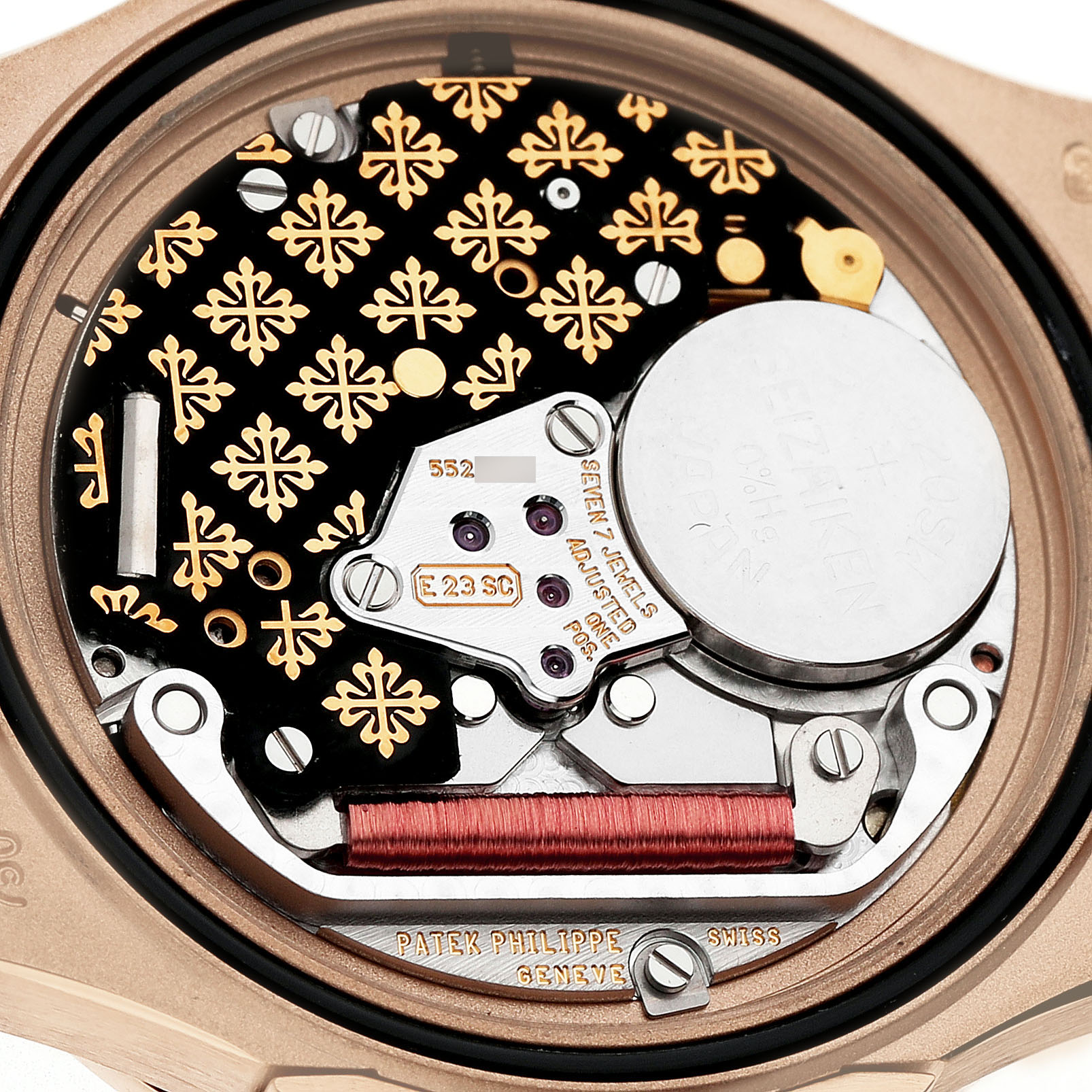 The image shows the movement of a Patek Philippe Nautilus 7010R Women's Rose Gold Brown Dial, highlighting its intricate components and decorative details from the back.