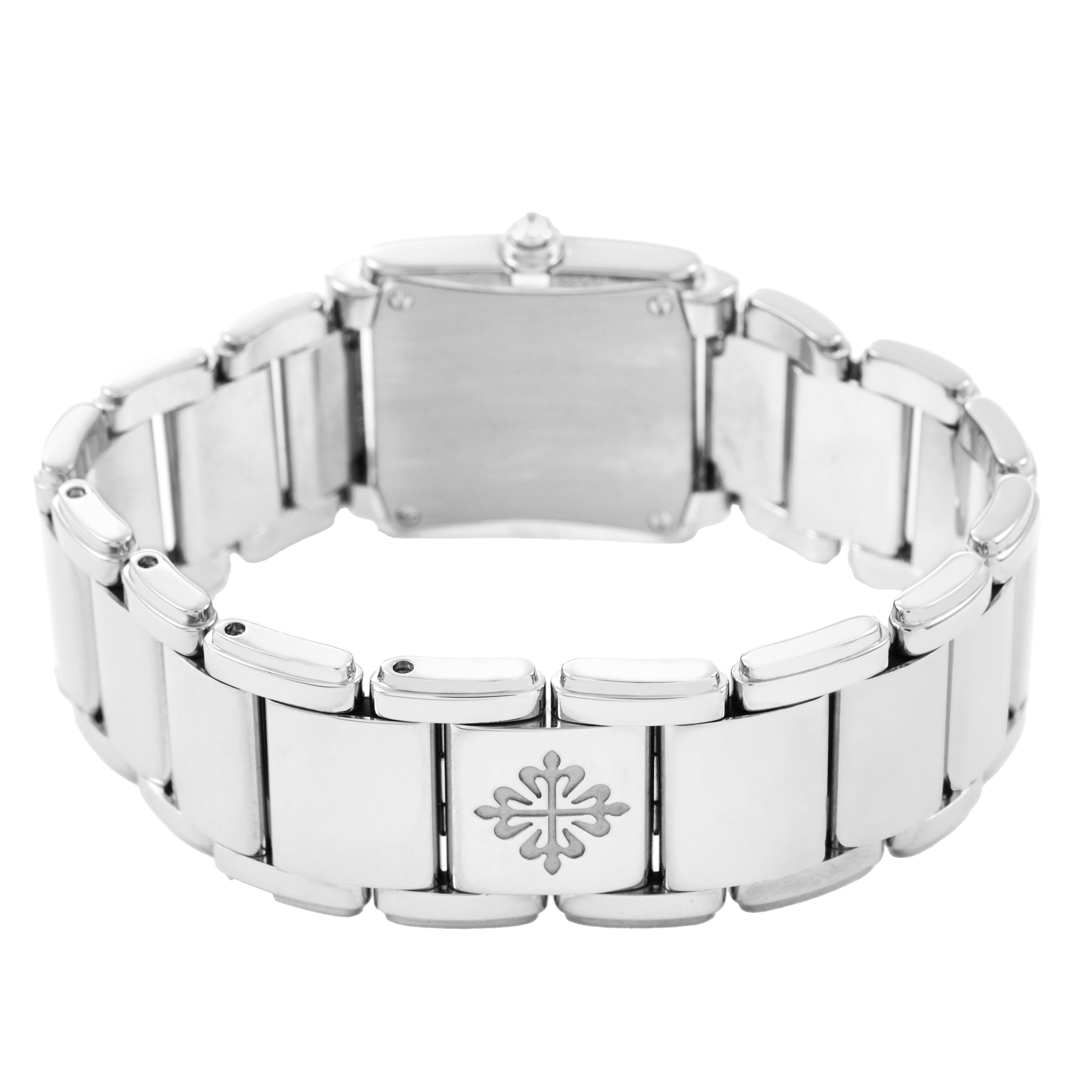 The image shows the back and bracelet of a Patek Philippe Twenty-4 4908/200G-011 Women's White Gold Black Dial watch, featuring the brand's emblem.