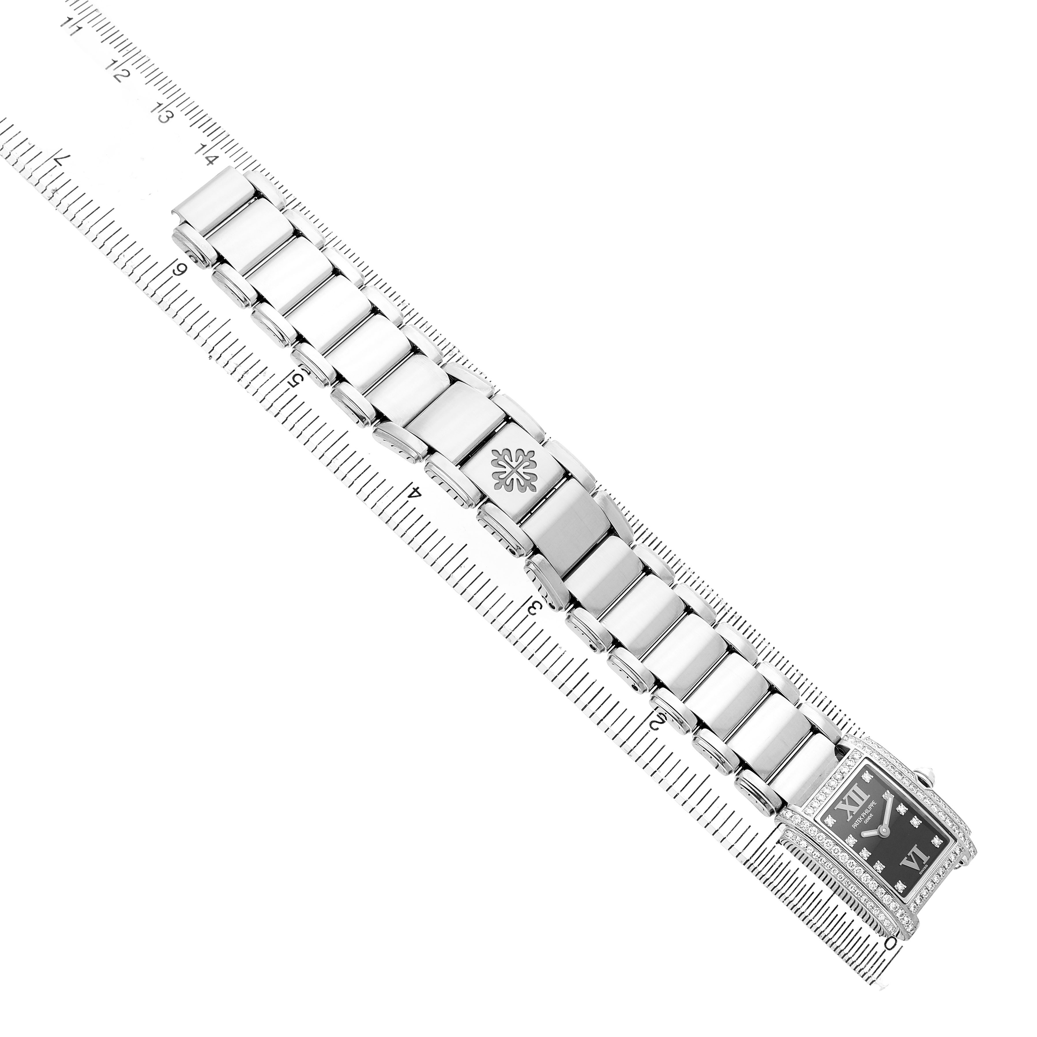 The Patek Philippe Twenty-4 4908/200G-011 Women's White Gold Black Dial watch is shown from the top view, highlighting its bracelet and clasp.