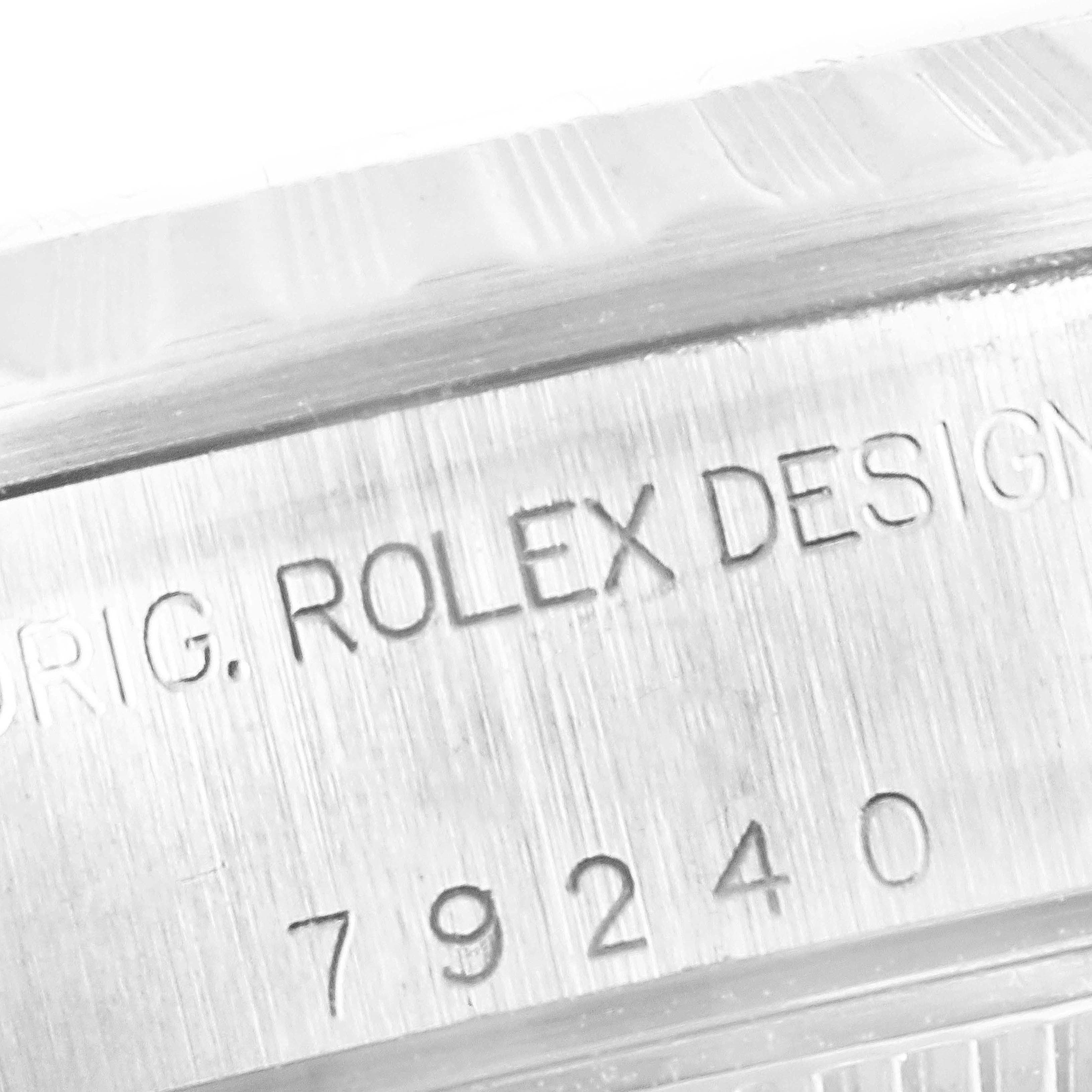 The image shows a close-up of the case edge of a Rolex Date 79240 Women's Stainless Steel Black Dial 79240 Women's Stainless Steel Black Dial watch, highlighting the engraved model number and "ROLEX DESIGN."