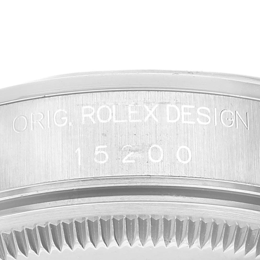 This image shows the side of a Rolex Date 15200 Men's Stainless Steel Blue Dial 15200 Men's Stainless Steel Blue Dial model watch, focusing on the engraved "ORIG. ROLEX DESIGN 15200."