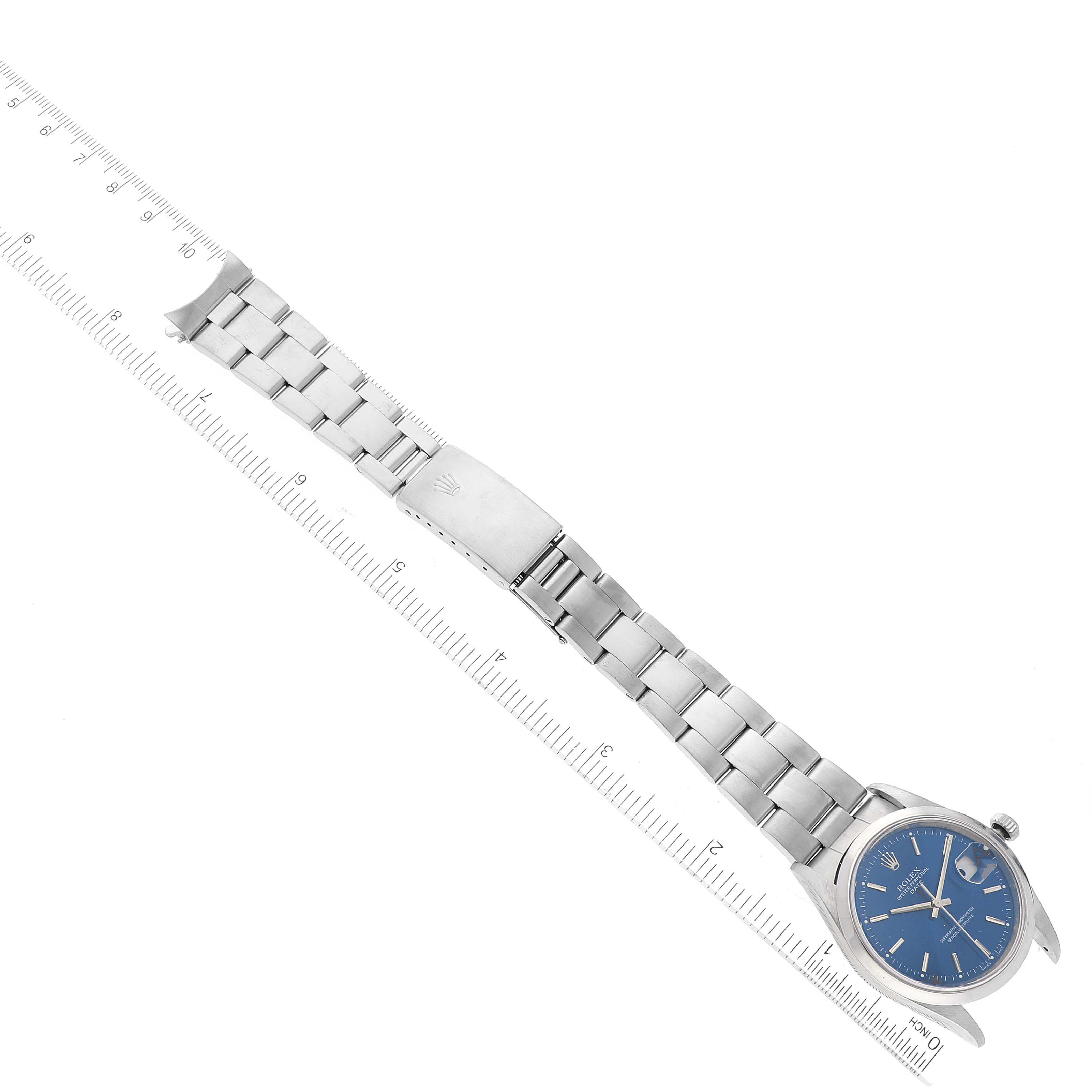 The image shows a full view of a Rolex Date 15200 Men's Stainless Steel Blue Dial 15200 Men's Stainless Steel Blue Dial model watch, including the face, bracelet, and clasp, placed next to a ruler for scale.