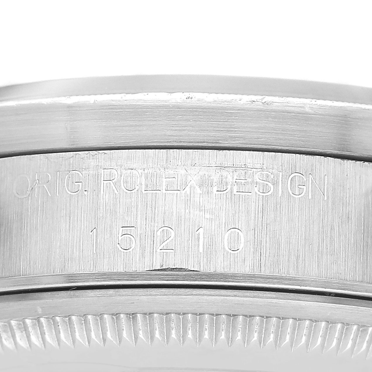 The image shows a close-up of the side engraving on the bezel of a Rolex Date 15210 Men's Stainless Steel Blue Dial model watch.