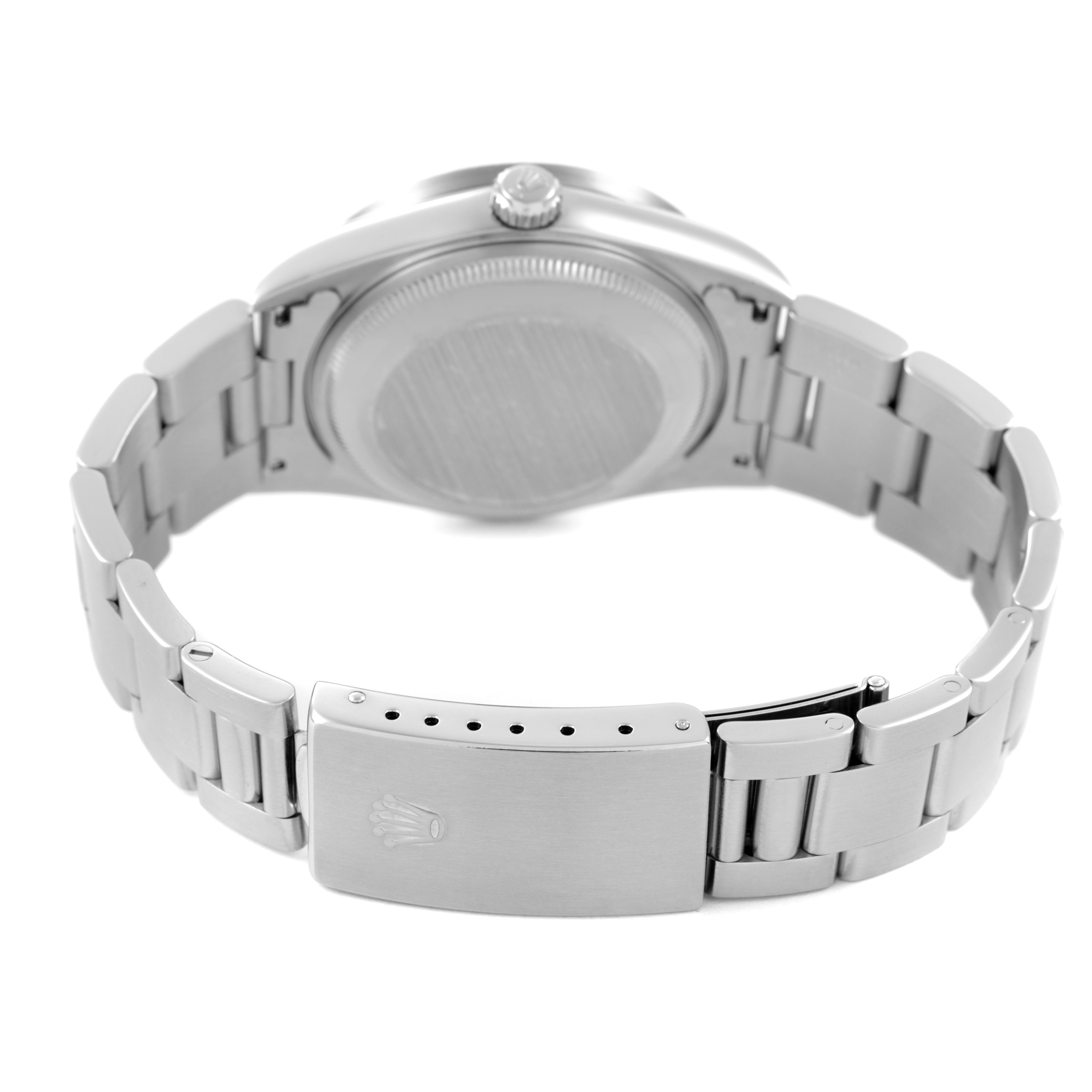 The image shows the back and clasp of a Rolex Date 15210 Men's Stainless Steel Blue Dial model, highlighting the bracelet and case back.