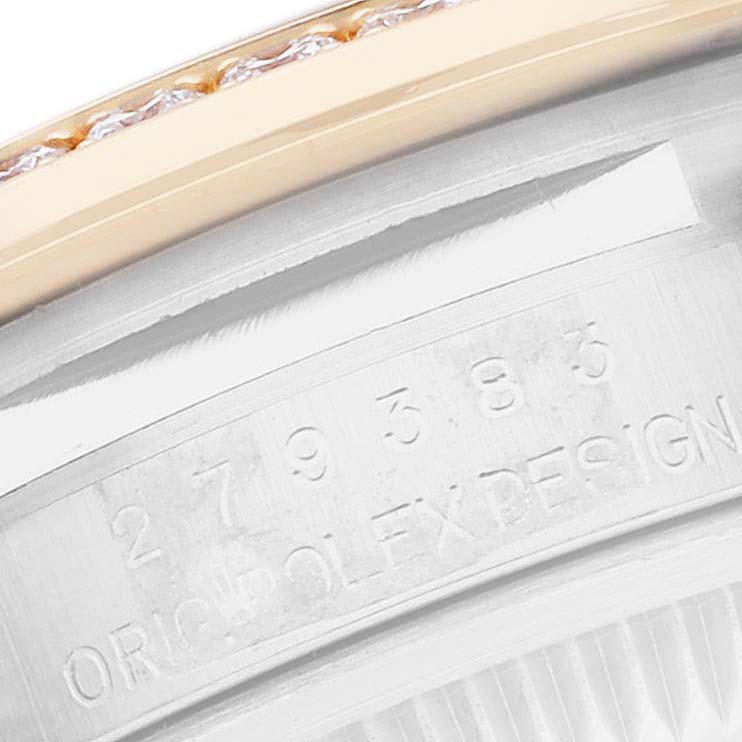 The image shows a close-up of the Rolex Datejust 279383 Women
s Steel and Gold (two tone) Champagne Dial model
s serial number engraving, partially revealing the fluted bezel and case.