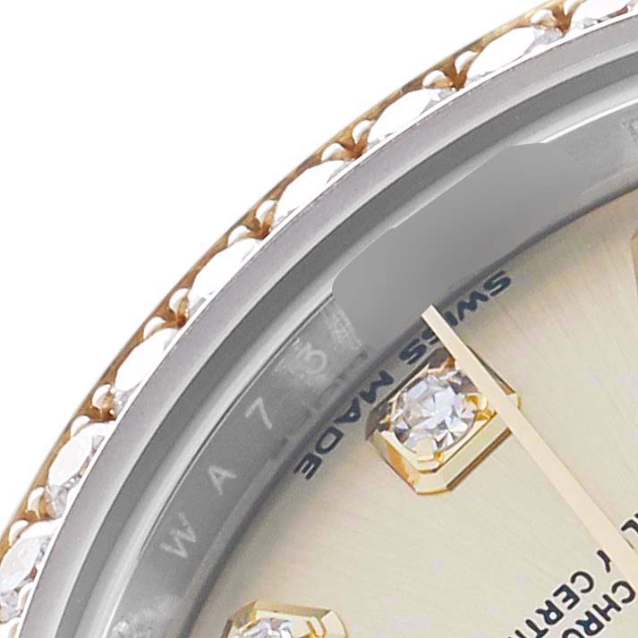 The image shows a close-up of the dial and bezel of a Rolex Datejust 279383 Women
s Steel and Gold (two tone) Champagne Dial, highlighting the diamond hour marker and "Swiss Made" text.