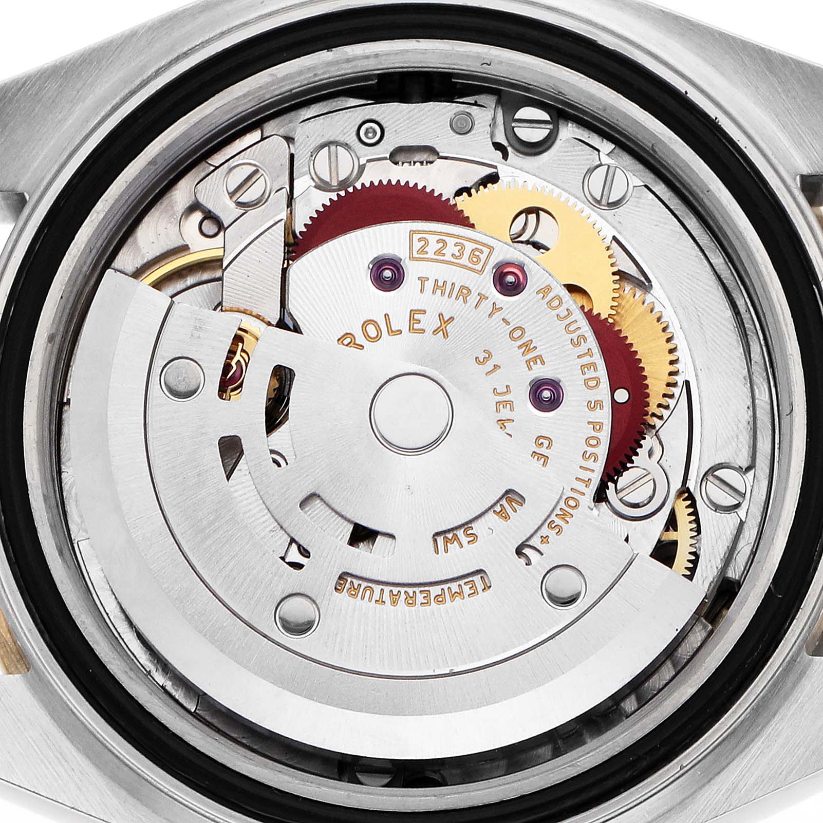 The image shows the movement of a Rolex Datejust 279383 Women
s Steel and Gold (two tone) Champagne Dial watch from a rear angle, highlighting gears and inscriptions.