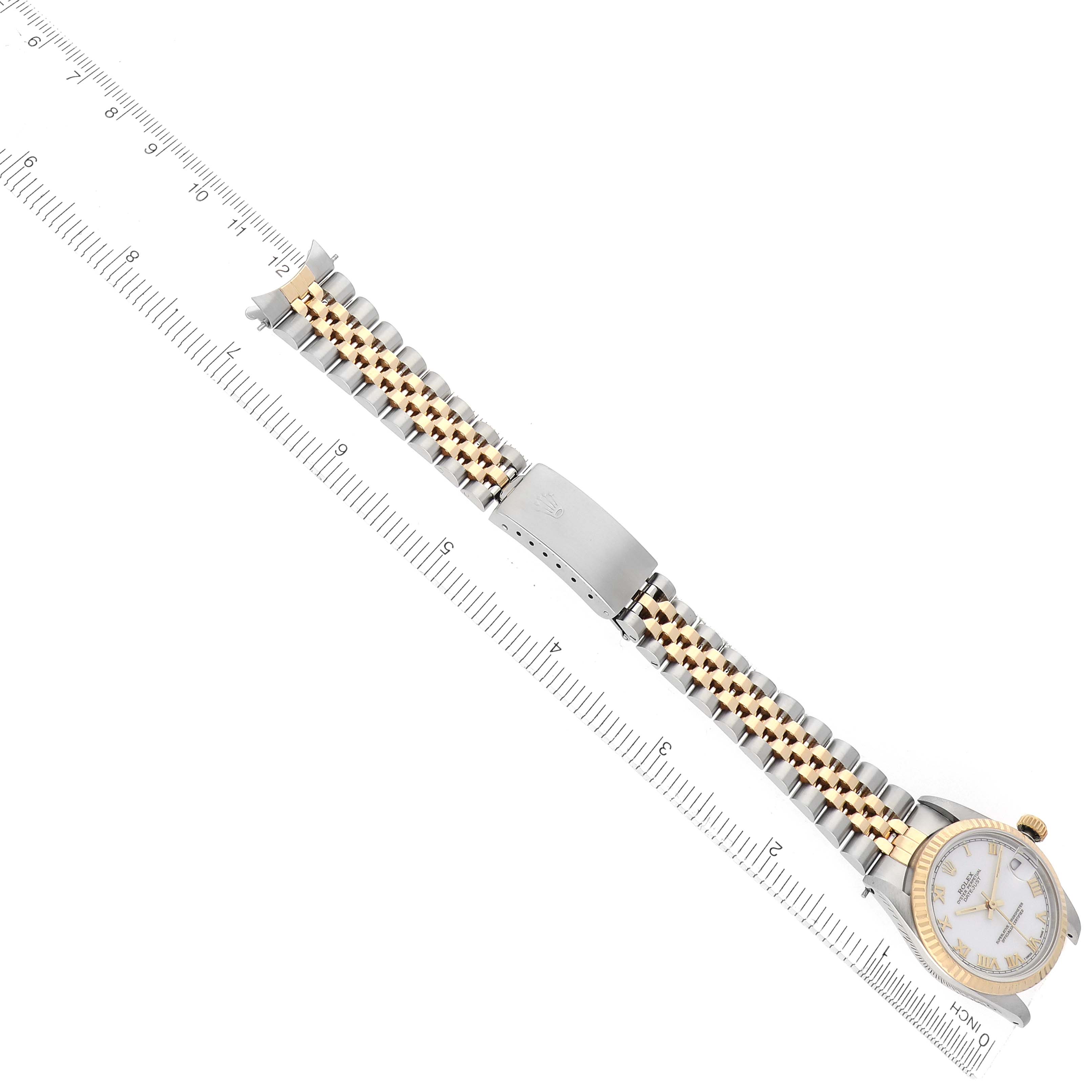 The Rolex Mid-Size 68273 Women
s Steel and Gold (two tone) White Dial watch is shown from a top angle, highlighting its full bracelet and face, with a ruler for scale.