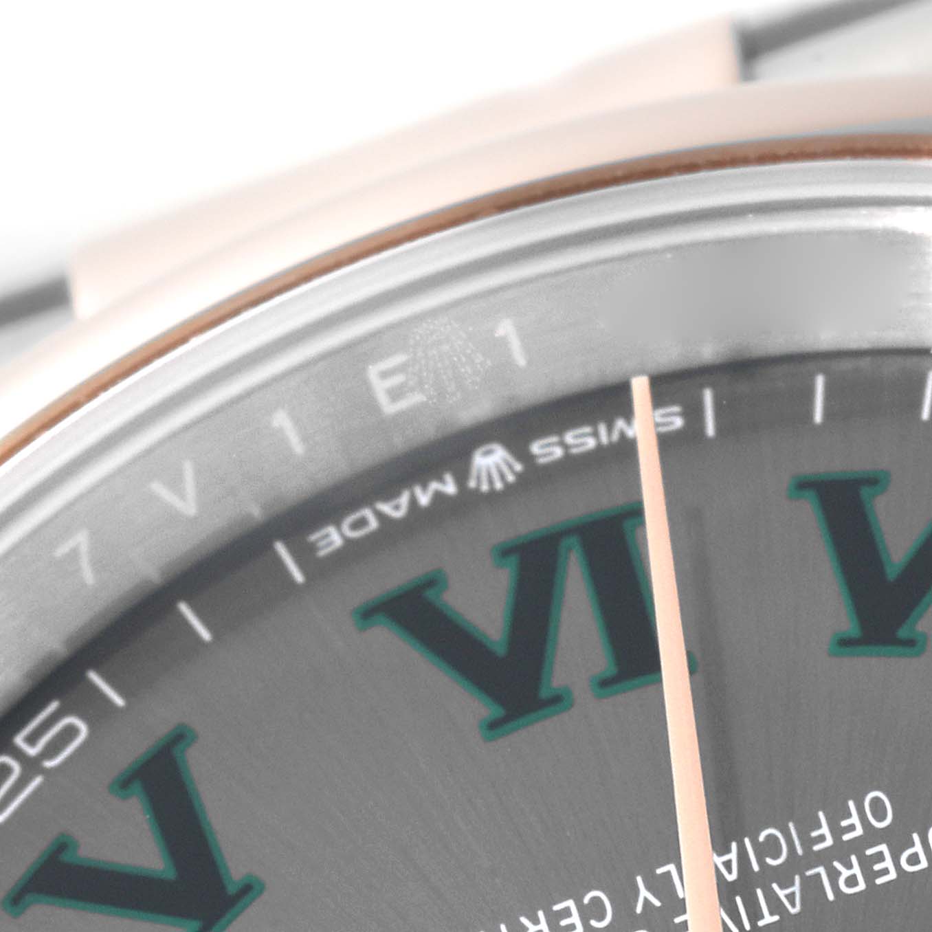 This close-up image of a Rolex Datejust 126201 Men's Steel and Gold (two tone) Grey Dial 126201 Men's Steel and Gold (two tone) Grey Dial watch shows part of the dial featuring "SWISS MADE" text and Roman numeral VI.