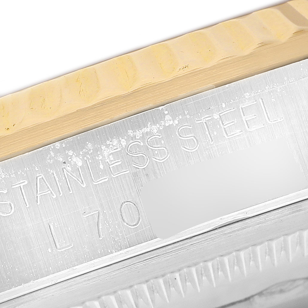The image shows a close-up of the bezel and case edge with engraving on a Rolex Datejust 16233 Men's Steel and Gold (two tone) Champagne Dial watch.