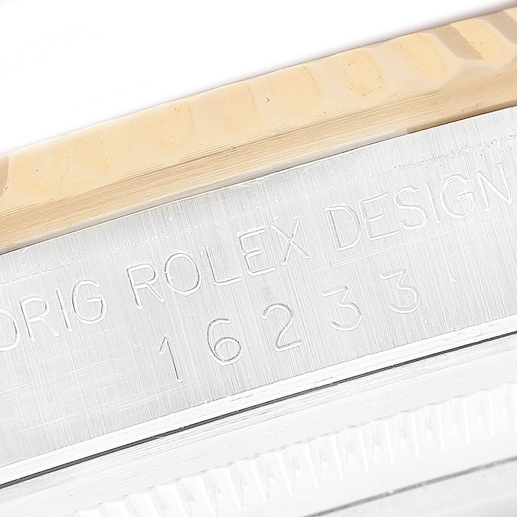 The image shows an angled close-up of a Rolex Datejust 16233 Men's Steel and Gold (two tone) Champagne Dial model's side, highlighting the engraved design and model number.