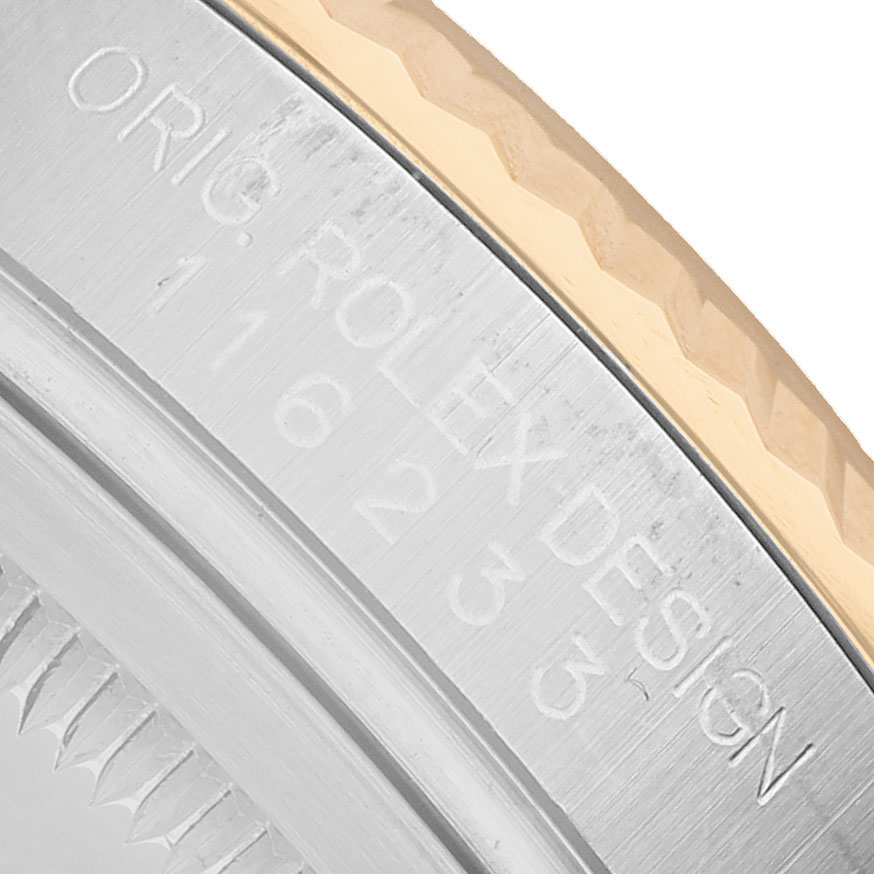 The image shows a close-up of the side of a Rolex Datejust 116233 Men's Steel and Gold (two tone) White Dial, highlighting the engraved markings on the case back.