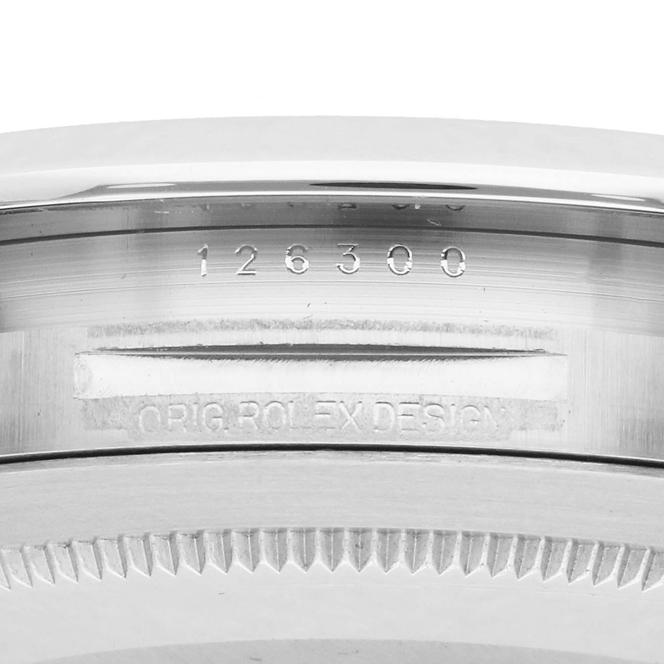 The image shows a close-up of the side of the Rolex Datejust 126300 Men
s Stainless Steel Silver Dial case, displaying the model number and "ORIG ROLEX DESIGN" engraving.