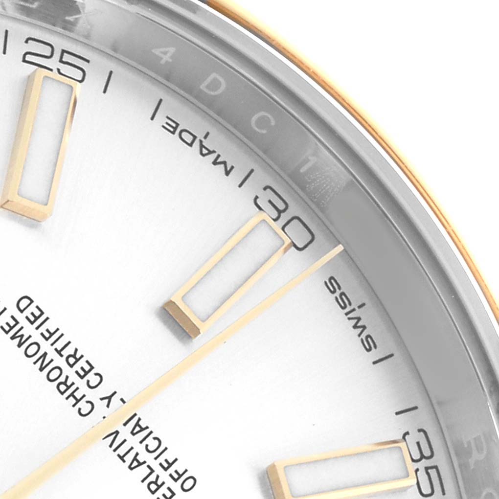 The image shows a close-up of the Rolex Datejust 41 126303 Men
s Steel and Gold (two tone) Silver Dial dial, focusing on the bezel, hour markers, and minute markings between 25 and 35.