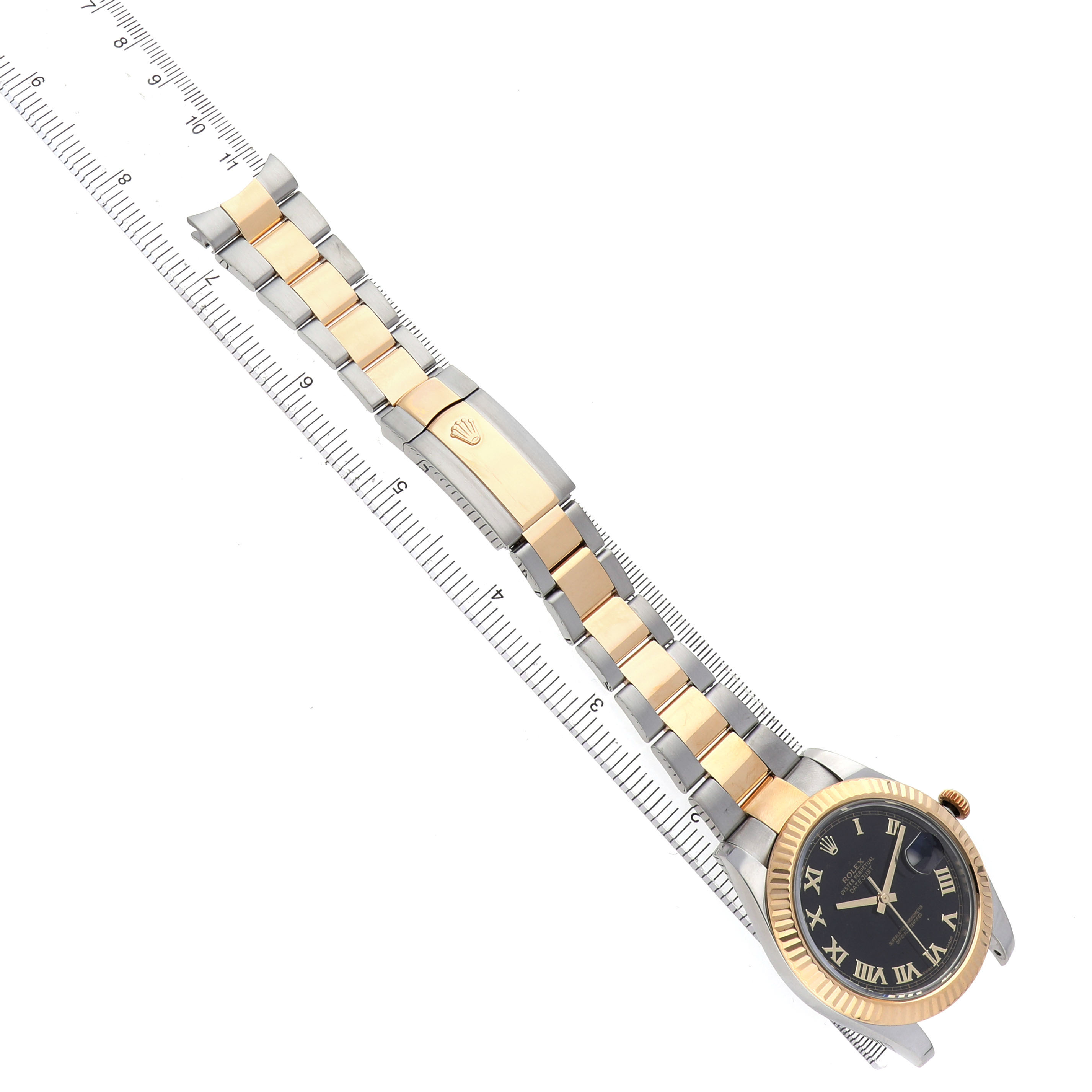 The Rolex Datejust 41 116333 Men's Steel and Gold (two tone) Black Dial is shown at an angle, displaying the face, bezel, and two-tone bracelet against a ruler for scale.