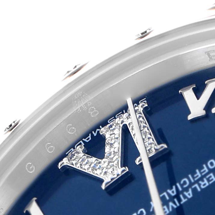 The Rolex Mid-Size 178344 Women
s Stainless Steel Blue Dial watch image shows a close-up of the dial with diamond-studded Roman numerals and part of the bezel.
