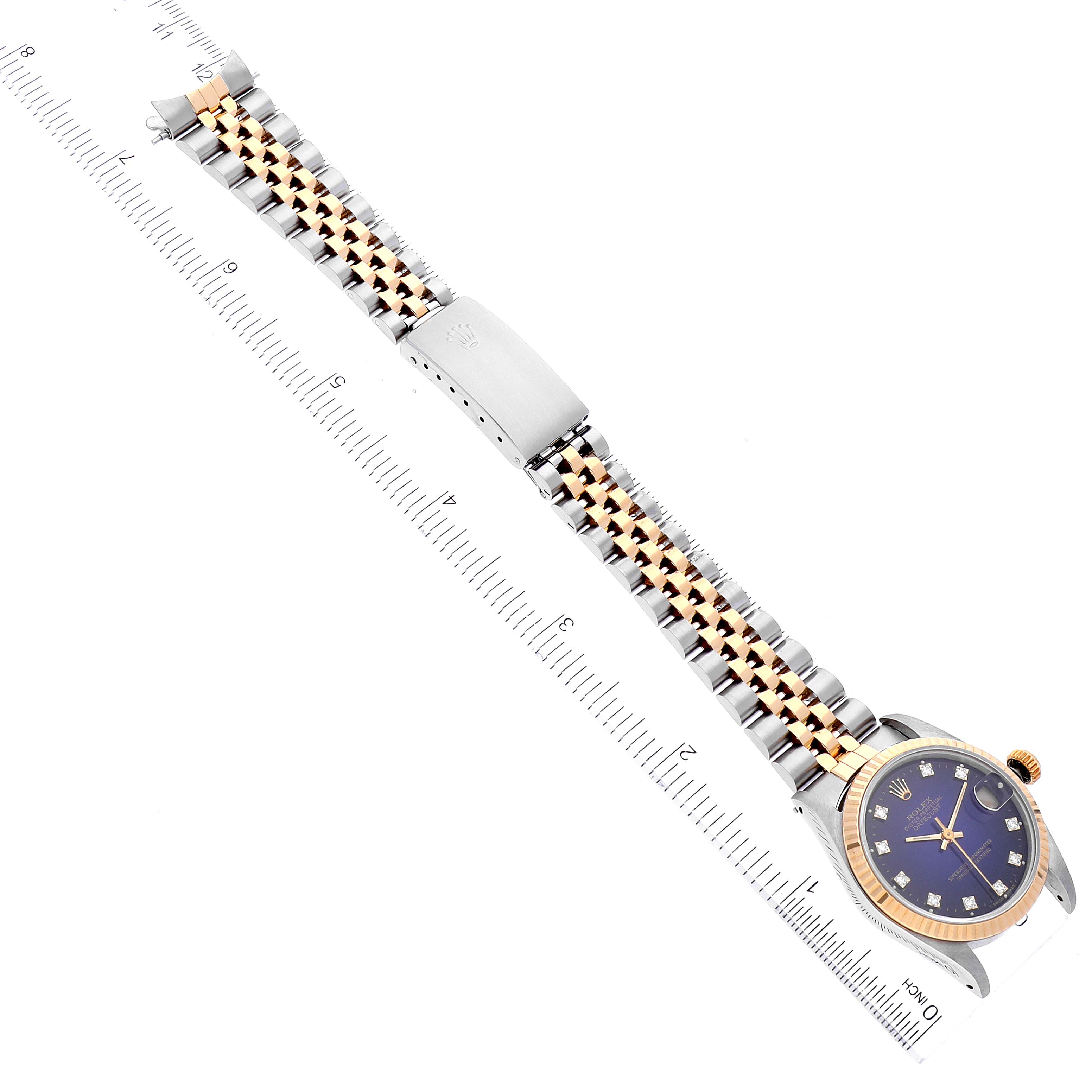 This is a top-down view of a Rolex Mid-Size 68273 Women's Steel and Gold (two tone) Blue Dial 68273 Women's Steel and Gold (two tone) Blue Dial watch, showing the full band, clasp, and face, aligned with a ruler for scale.
