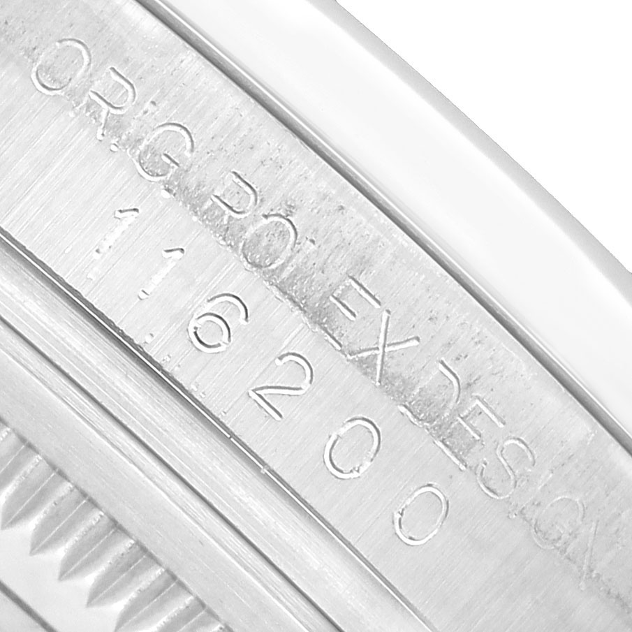 The image shows a close-up of the engraved inner bezel of a Rolex Datejust 116200 Men's Stainless Steel Blue Dial watch, displaying the model number.