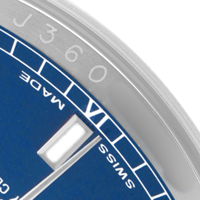 The image shows a close-up of the dial and chapter ring of a Rolex Datejust 116200 Men's Stainless Steel Blue Dial watch, focusing on the "Swiss Made" text and minute markers.