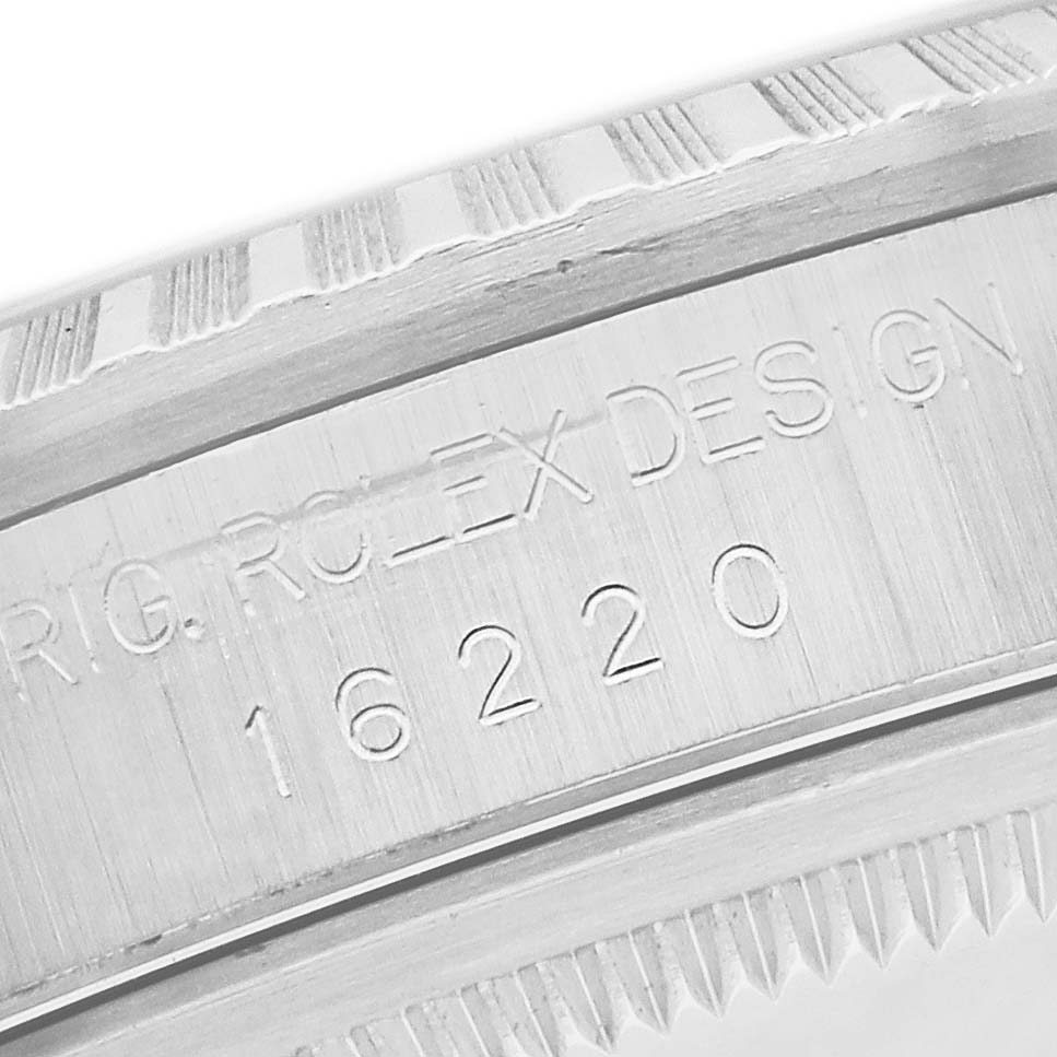 The image shows a close-up of the case side of a Rolex Datejust 16220 Men
s Stainless Steel Silver Dial, displaying engraving with model and design details.