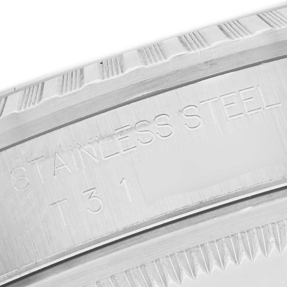 The image shows a close-up angle of the fluted bezel and part of the case back with engravings on the Rolex Datejust 16220 Men
s Stainless Steel Silver Dial.