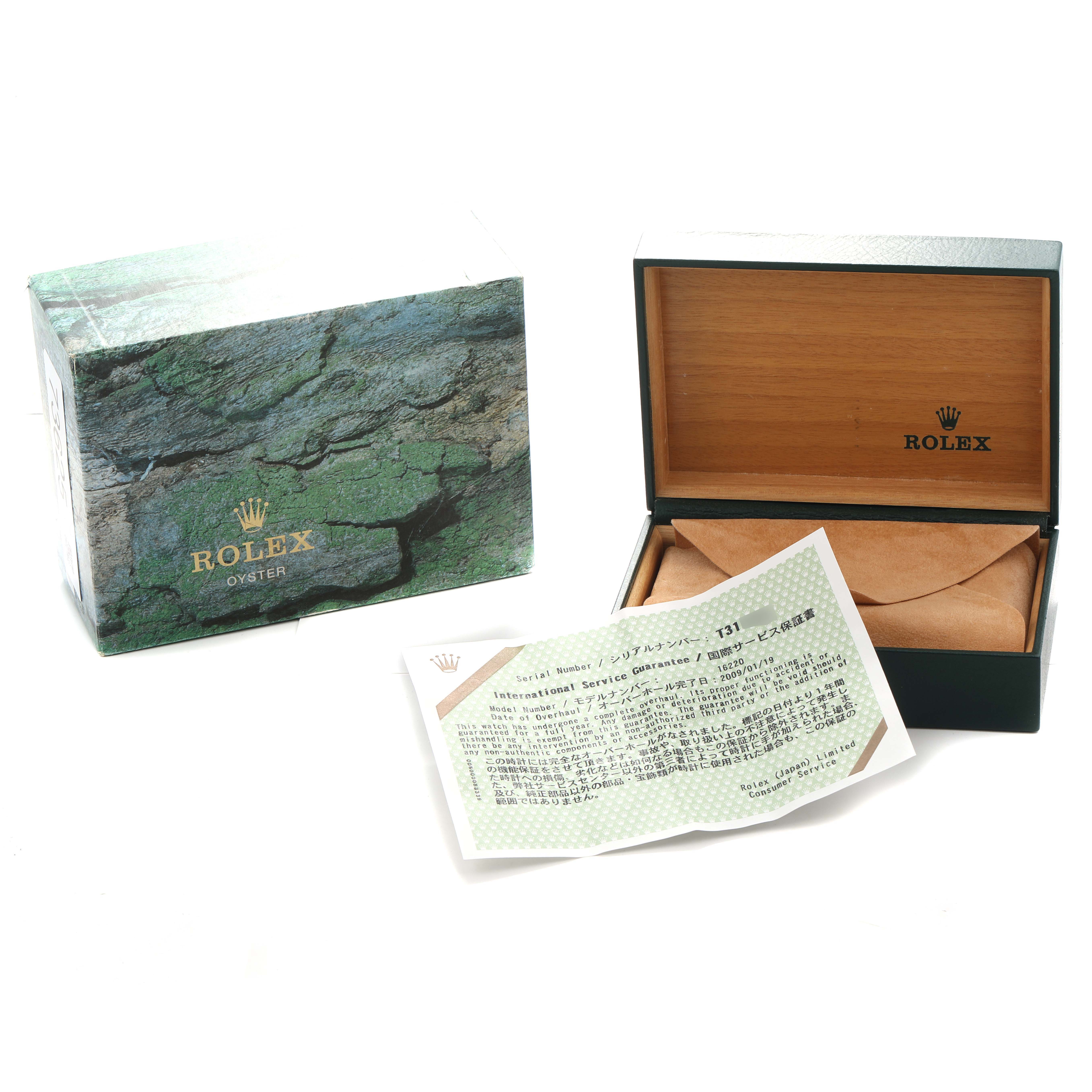 The image shows a Rolex Datejust 16220 Men
s Stainless Steel Silver Dial box, its outer packaging, and a warranty card from a top angle.