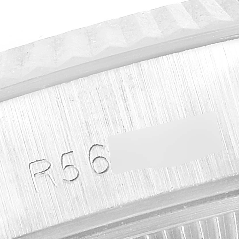 The image shows a close-up of the edge of the case and bezel of a Rolex Datejust 69174 Women's Stainless Steel Blue Dial 69174 Women's Stainless Steel Blue Dial watch, highlighting part of the serial number.