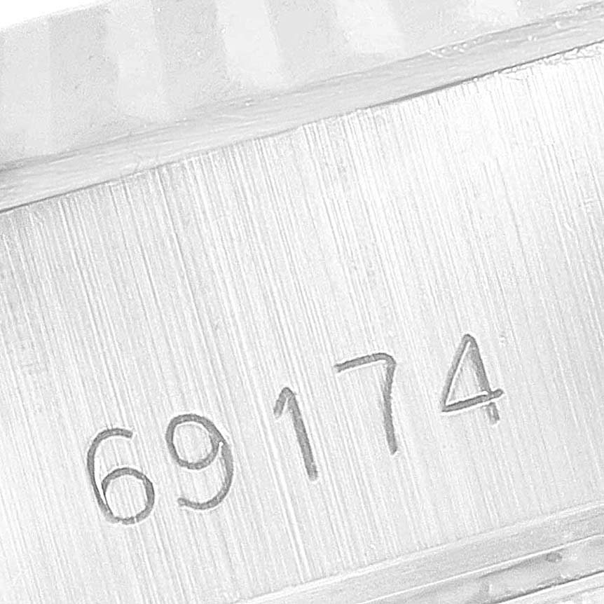 The image shows a close-up of the model number engraving, 69174, on a Rolex Datejust 69174 Women's Stainless Steel Blue Dial 69174 Women's Stainless Steel Blue Dial watch case.