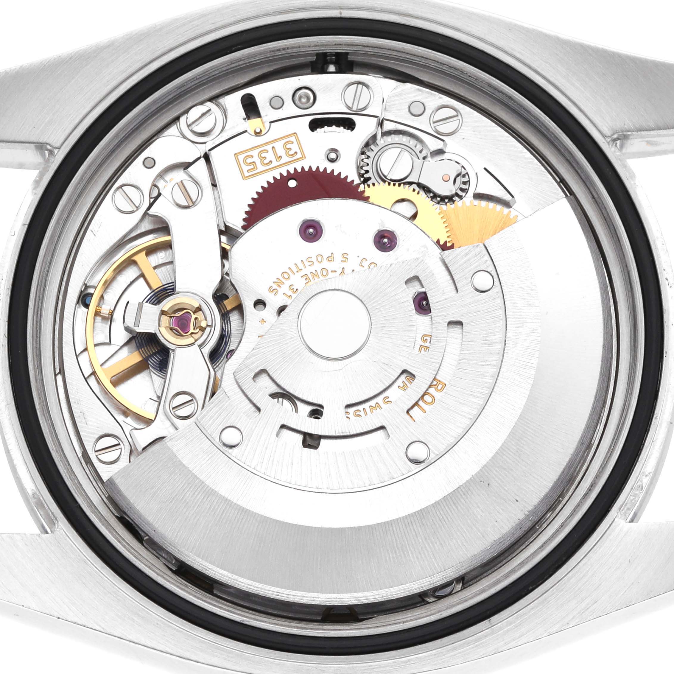 The image shows the movement of a Rolex Datejust 116200 Men
s Stainless Steel White Dial watch from a back angle, highlighting its intricate components.
