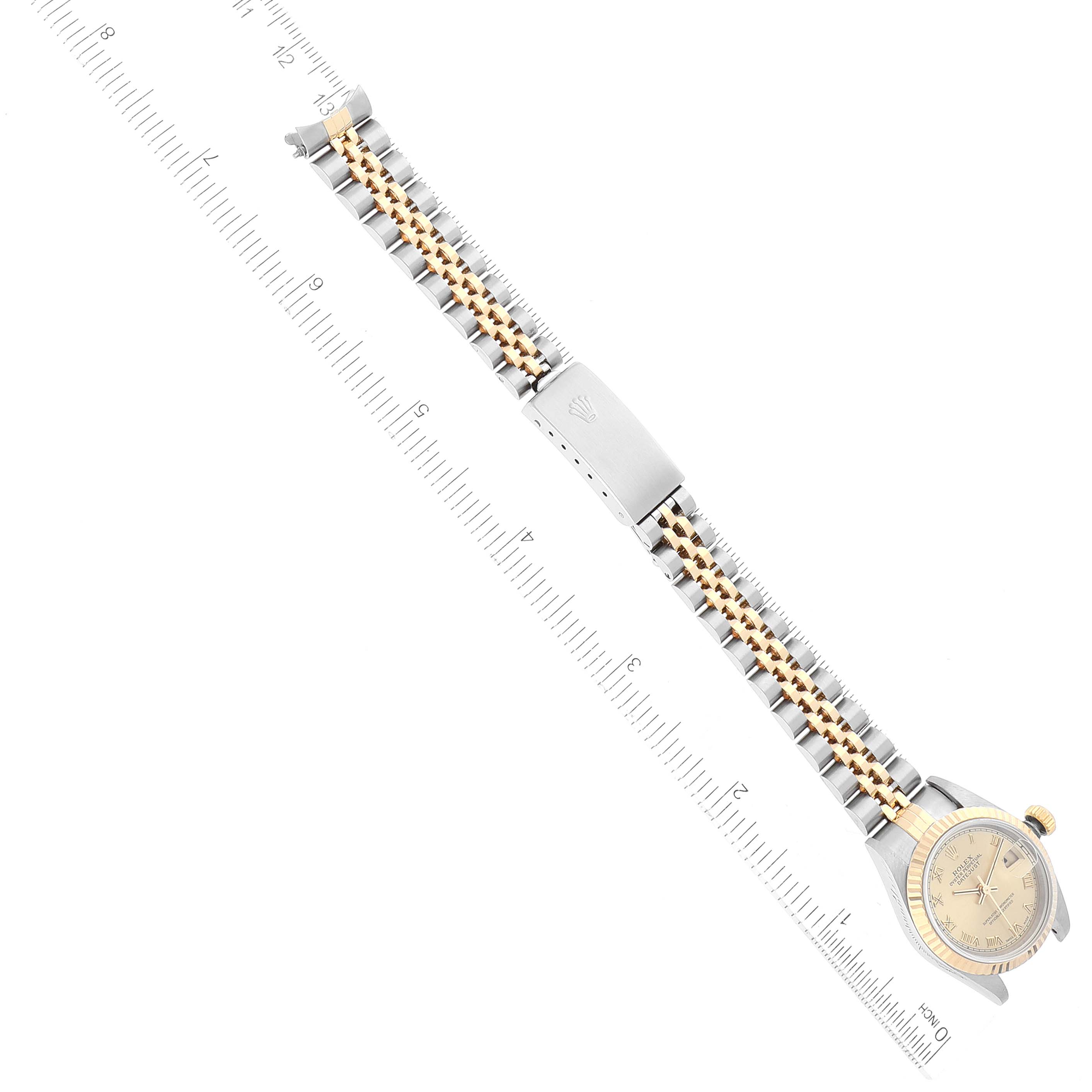 The image shows a Rolex Datejust 79173 Women's Steel and Gold (two tone) Champagne Dial 79173 Women's Steel and Gold (two tone) Champagne Dial watch horizontally, highlighting the full length of the band and part of the watch face with a measuring ruler beside it.