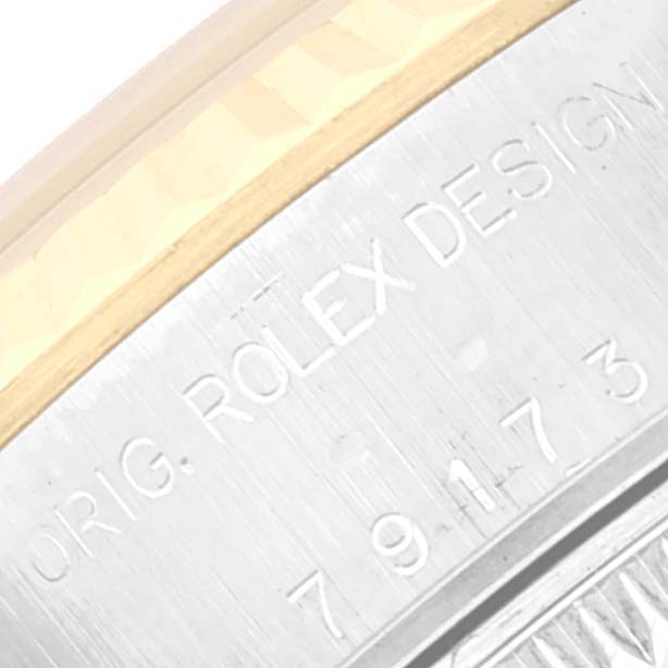 This image shows a close-up of the side of a Rolex Datejust 79173 Women's Steel and Gold (two tone) Champagne Dial 79173 Women's Steel and Gold (two tone) Champagne Dial watch, displaying "ORIG. ROLEX DESIGN" engraving.