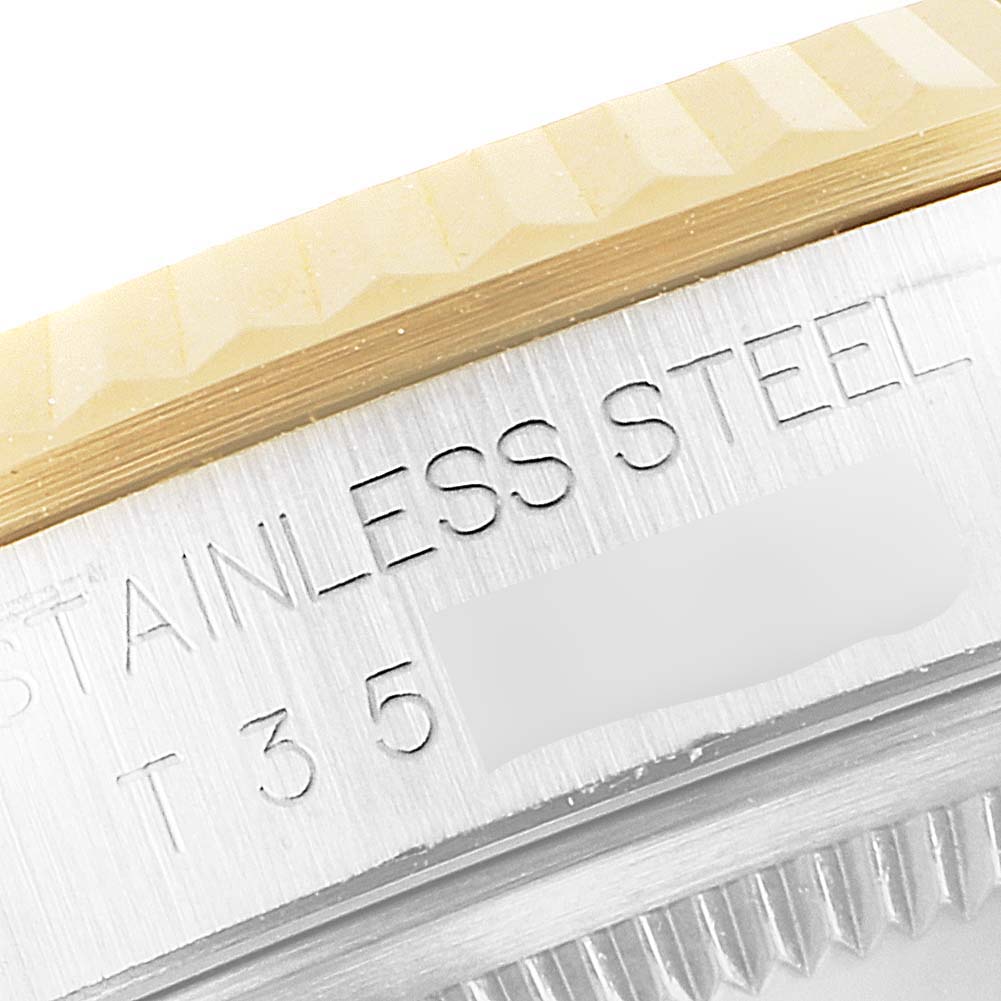 This close-up image shows the edge of the stainless steel case and part of the bezel of a Rolex Datejust 16233 Men's Steel and Gold (two tone) Champagne Dial 16233 Men's Steel and Gold (two tone) Champagne Dial watch.