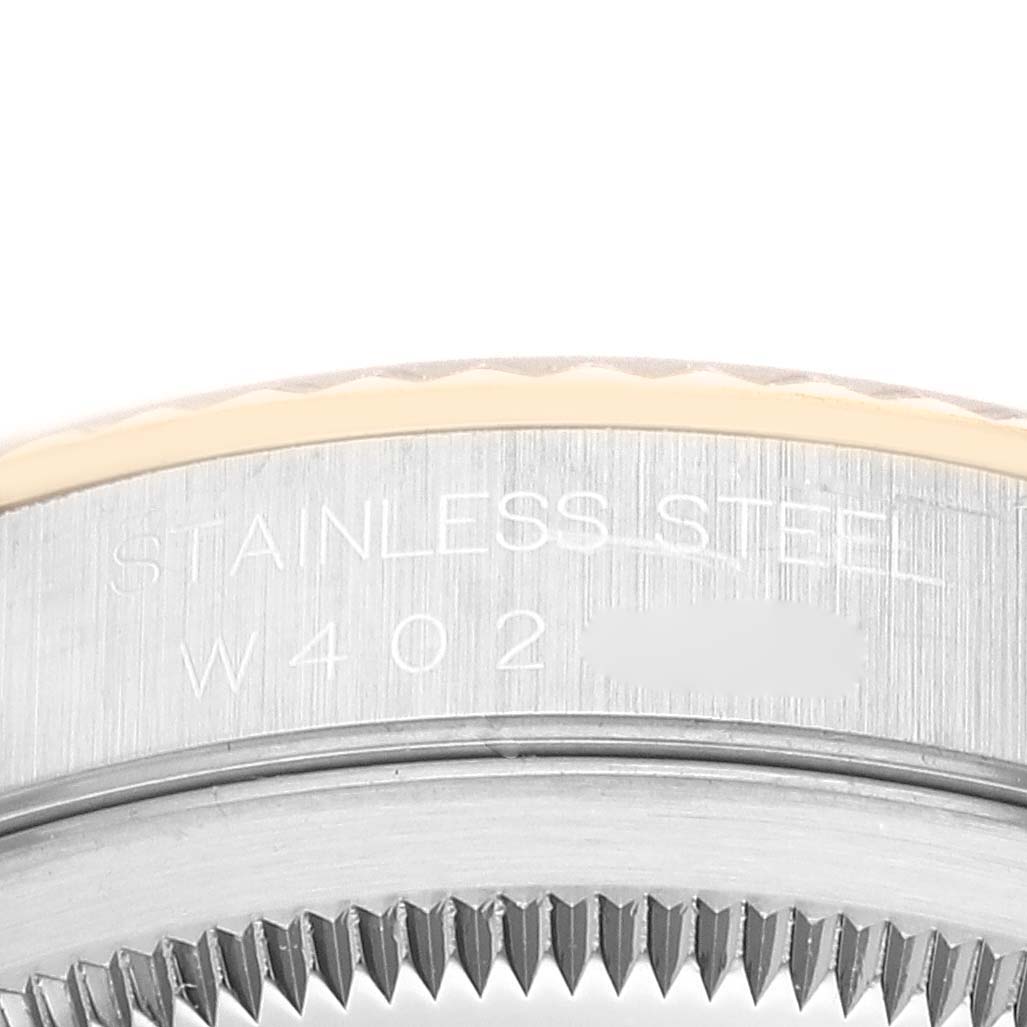 This close-up image shows the stainless steel side of the bezel on a Rolex Datejust 16233 Men's Steel and Gold (two tone) White Dial 16233 Men's Steel and Gold (two tone) White Dial watch, including part of its engraved serial number.