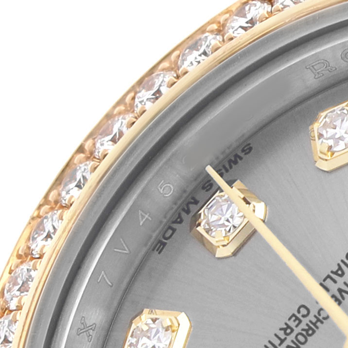 The image shows a close-up of the Rolex Datejust 179383 Women's Steel and Gold (two tone) Grey Dial model's bezel with diamonds and part of the dial with markers.