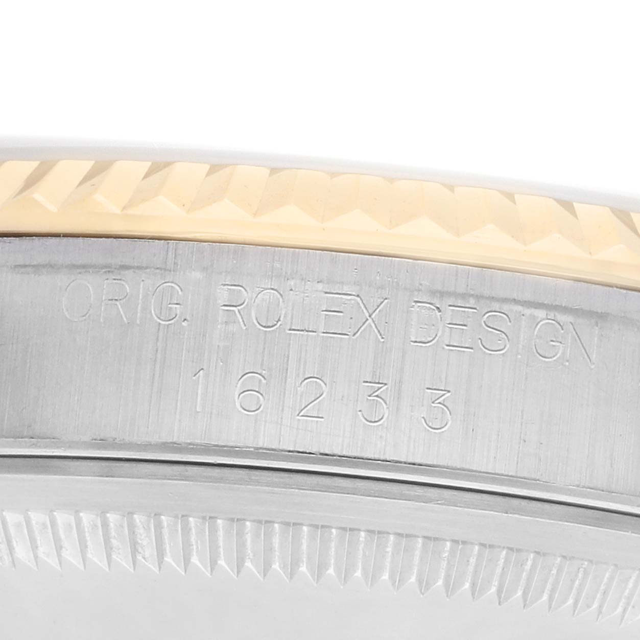 The image shows a close-up of the Rolex Datejust 16233 Men
s Steel and Gold (two tone) Beige Dial
s side case, highlighting the model number and the fluted bezel edge.