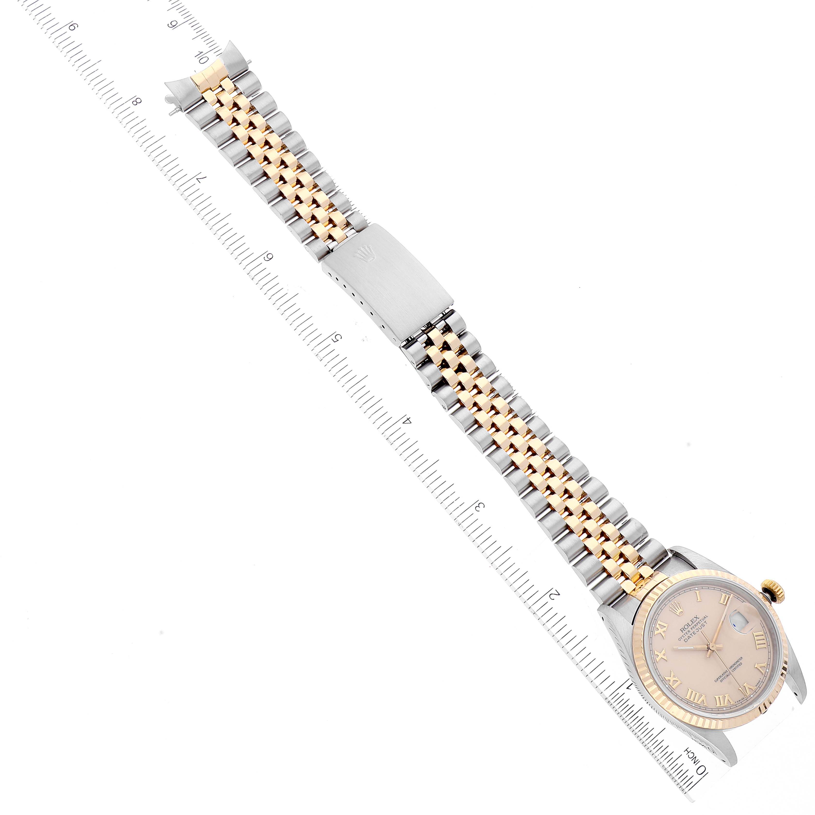 The image shows a Rolex Datejust 16233 Men's Steel and Gold (two tone) Beige Dial 16233 Men's Steel and Gold (two tone) Beige Dial watch at a top-down angle, highlighting its face and jubilee bracelet with a ruler for scale.